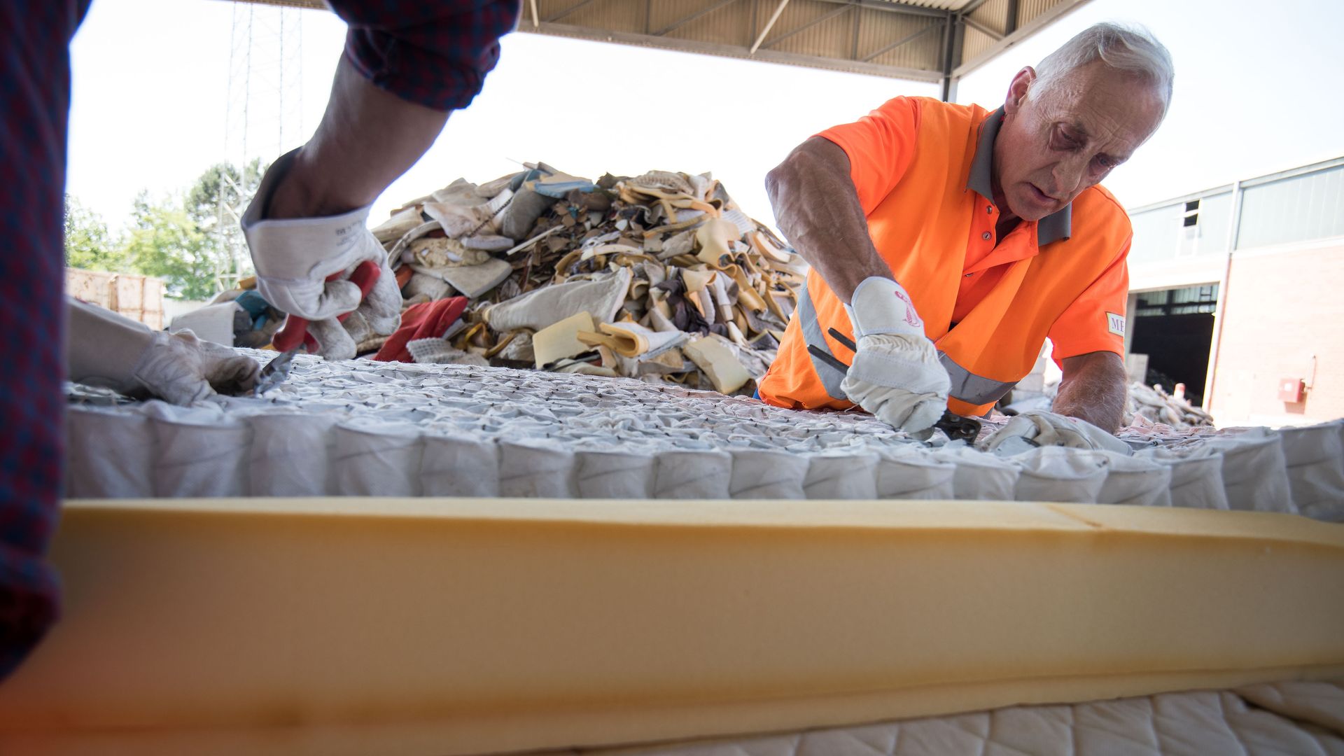 Workers dismantle a mattress in Germany. Photo: Thomas Lohnes/Getty Images