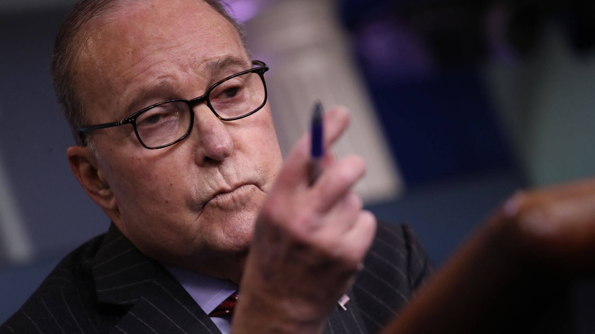 White House economic adviser Larry Kudlow points with a pen