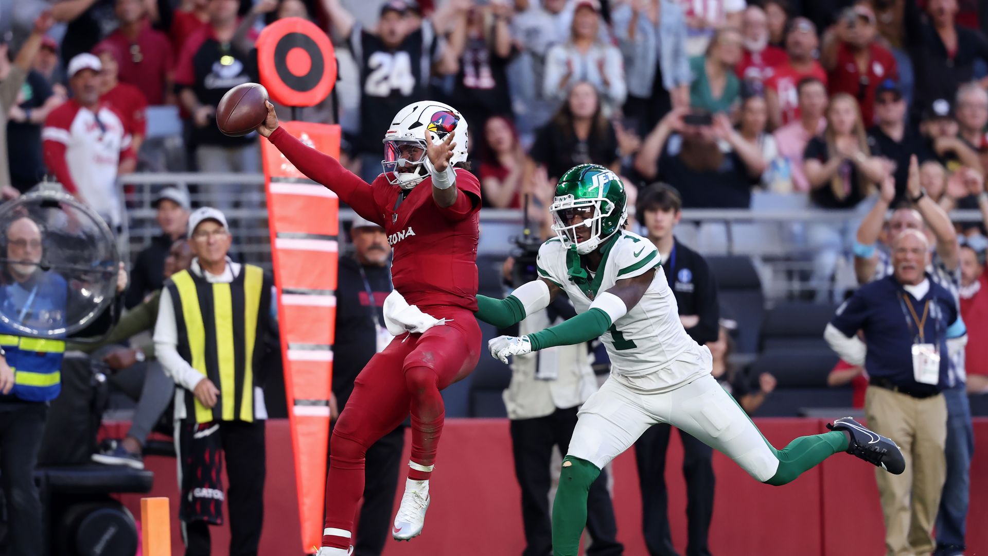 Kyler Murray celebrates in the end zone as he scores a rushing touchdown past Sauce Gardner.