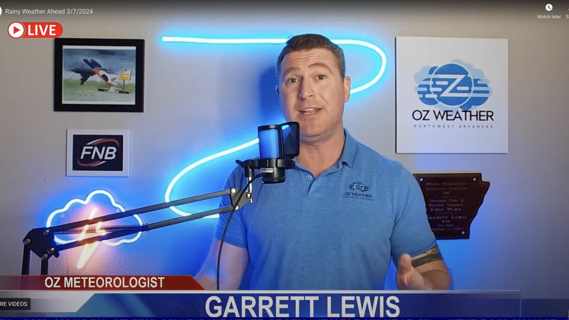 A screenshot of meteorologist Garrett Lewis giving a weather forecast from a home studio.