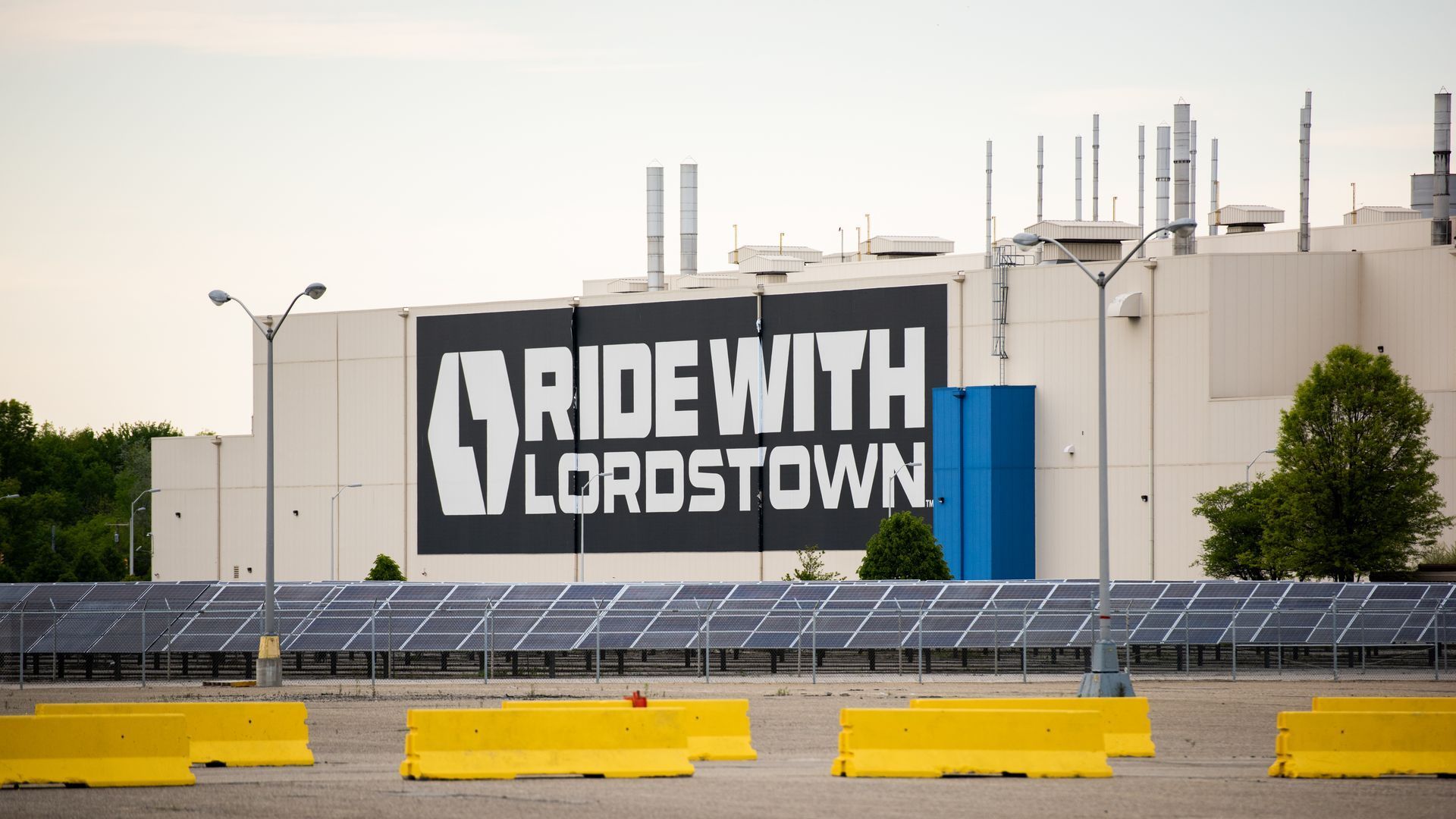 A factory with a big sign saying "ride with Lordstown."