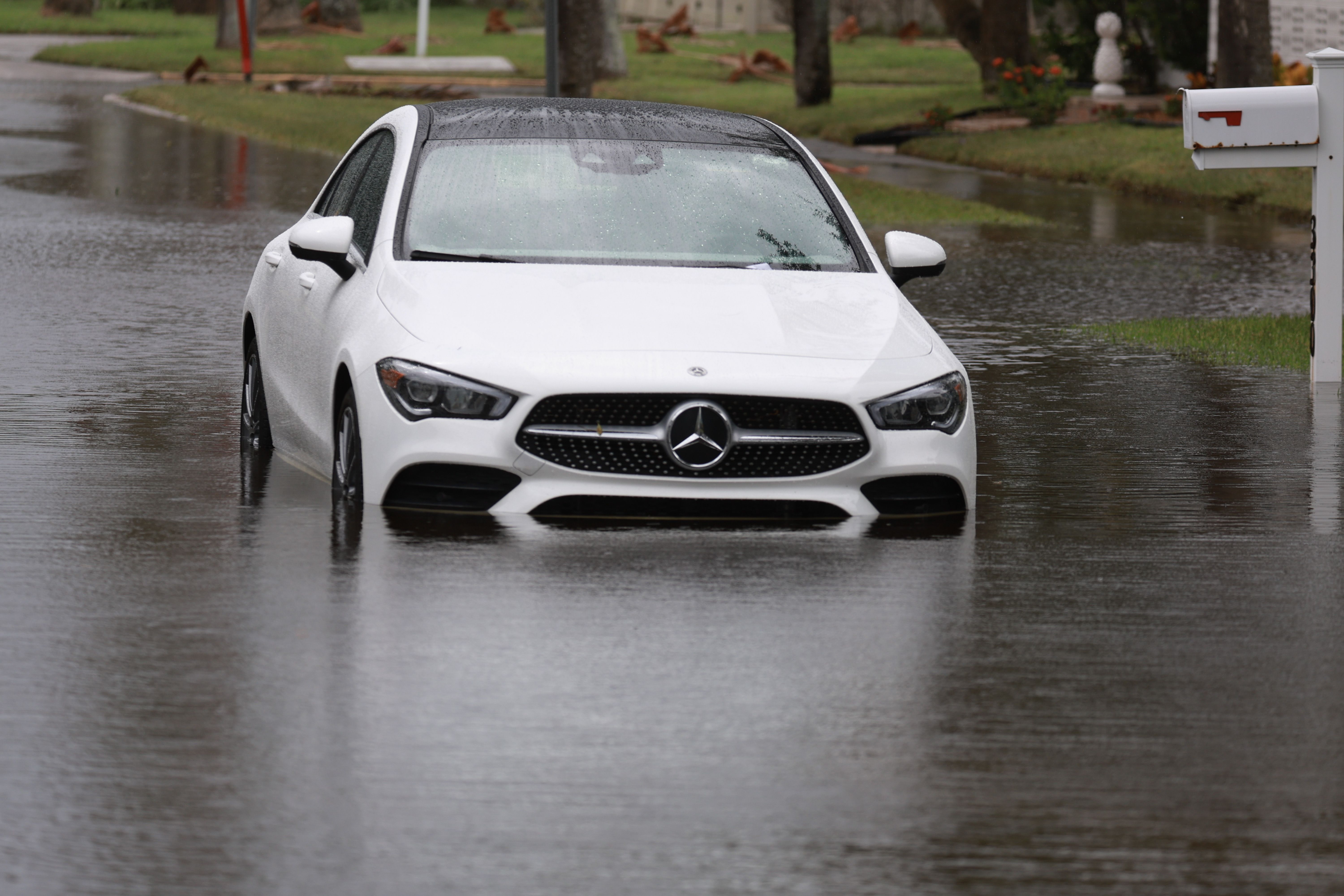 A white Mercedes stuck in surge water in St. Pete. 