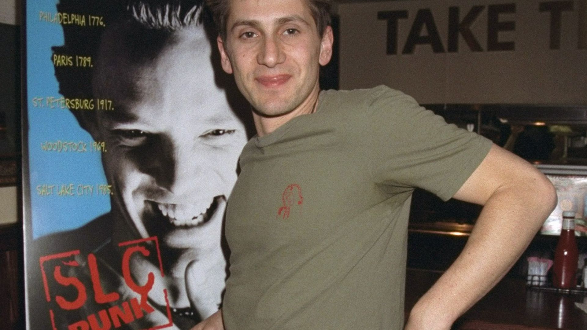 Actor Michael Goorjia stands next to the movie poster for "SLC Punk!" in 1999. Photo: Richard Corkery/NY Daily News Archive via Getty Images