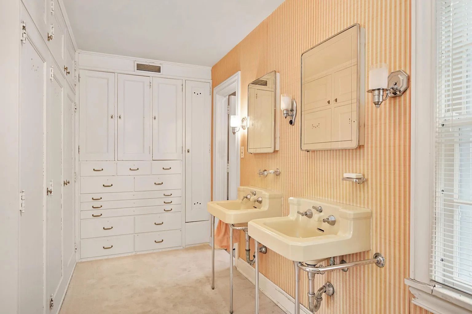 A closet with multiple large white cabinets.