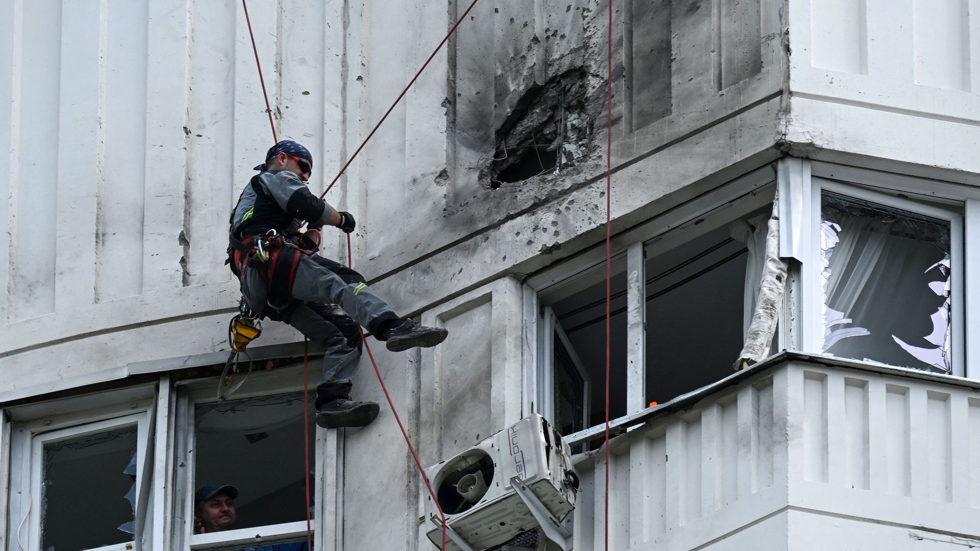 A specialist inspects the damaged facade of a multi-storey apartment building after a reported drone attack in Moscow on May 30, 2023. (Photo by Kirill KUDRYAVTSEV / AFP