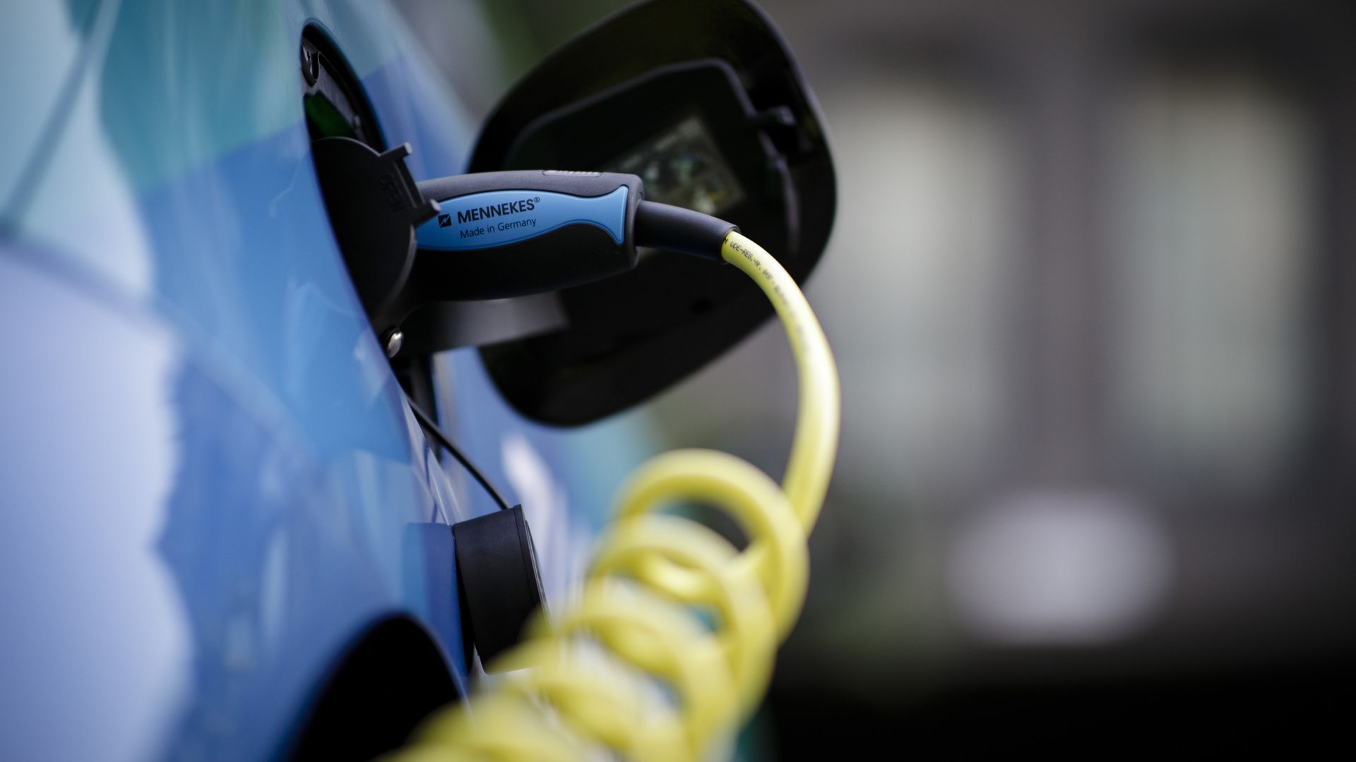A close-up of an electric car being charged. 