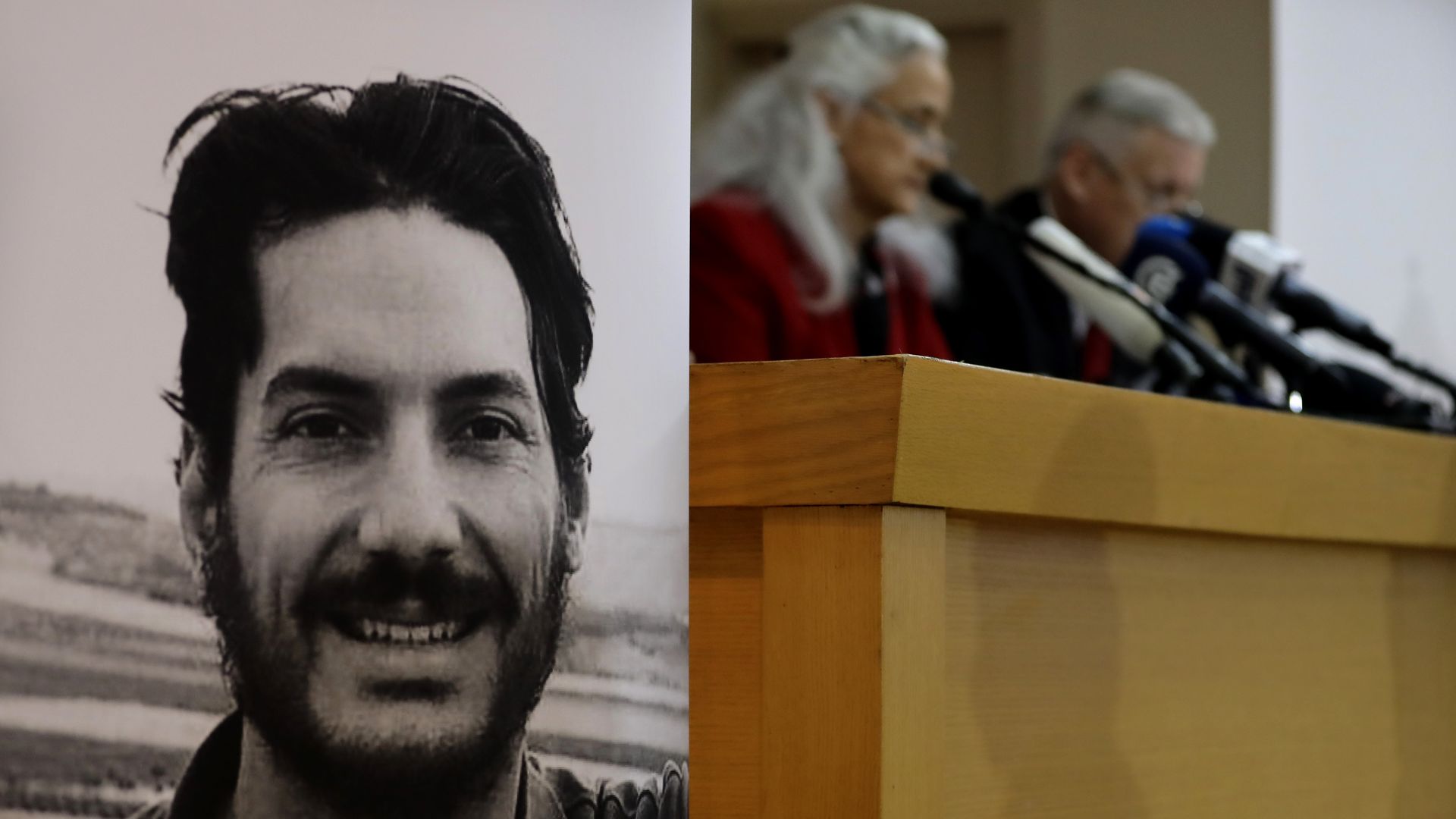 Marc and Debra Tice next to a photo of US journalist Austin Tice