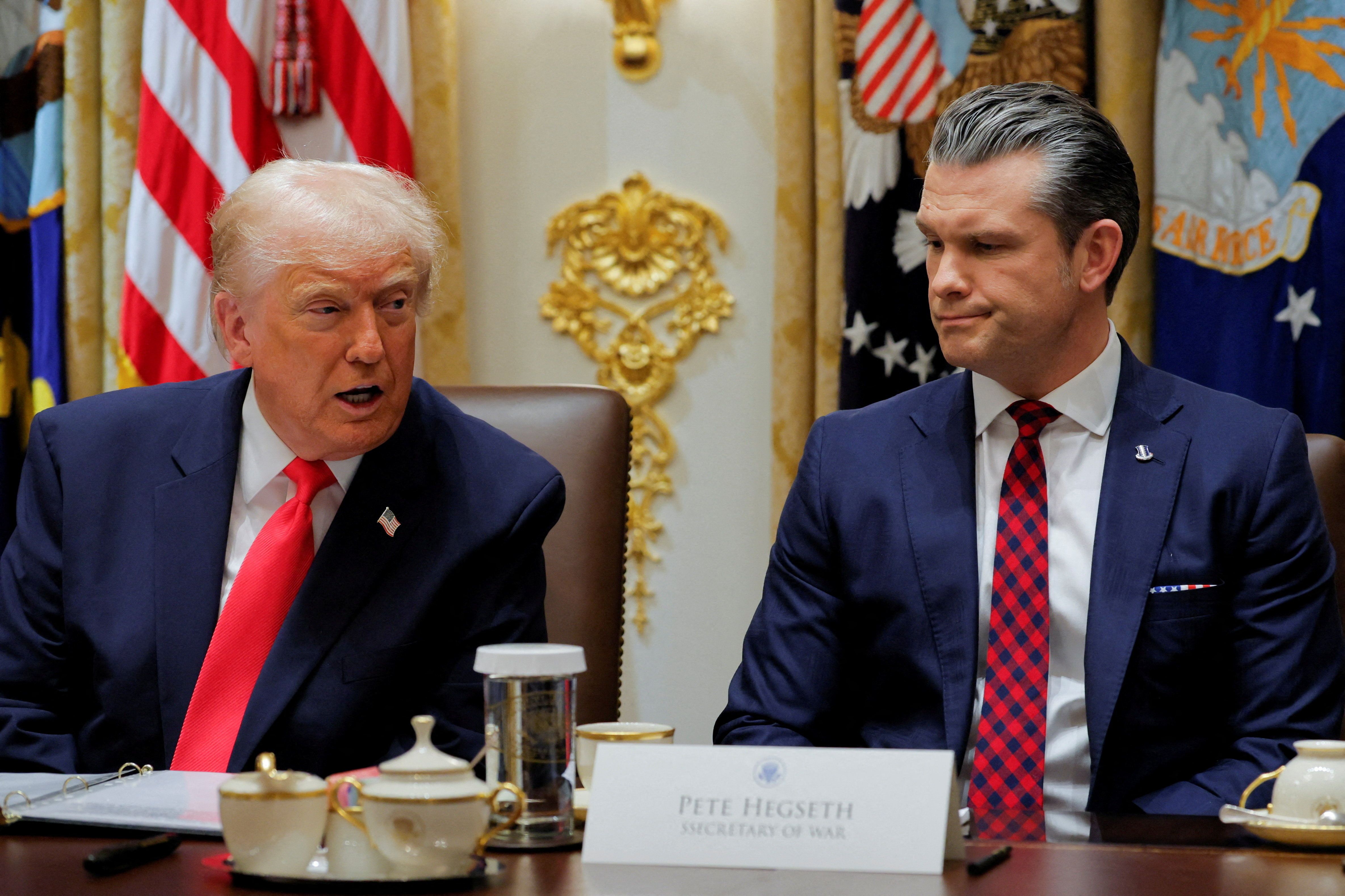 President Trump — sitting next to Defense Secretary Pete Hegseth — speaks at a Cabinet meeting in the White House yesterday.