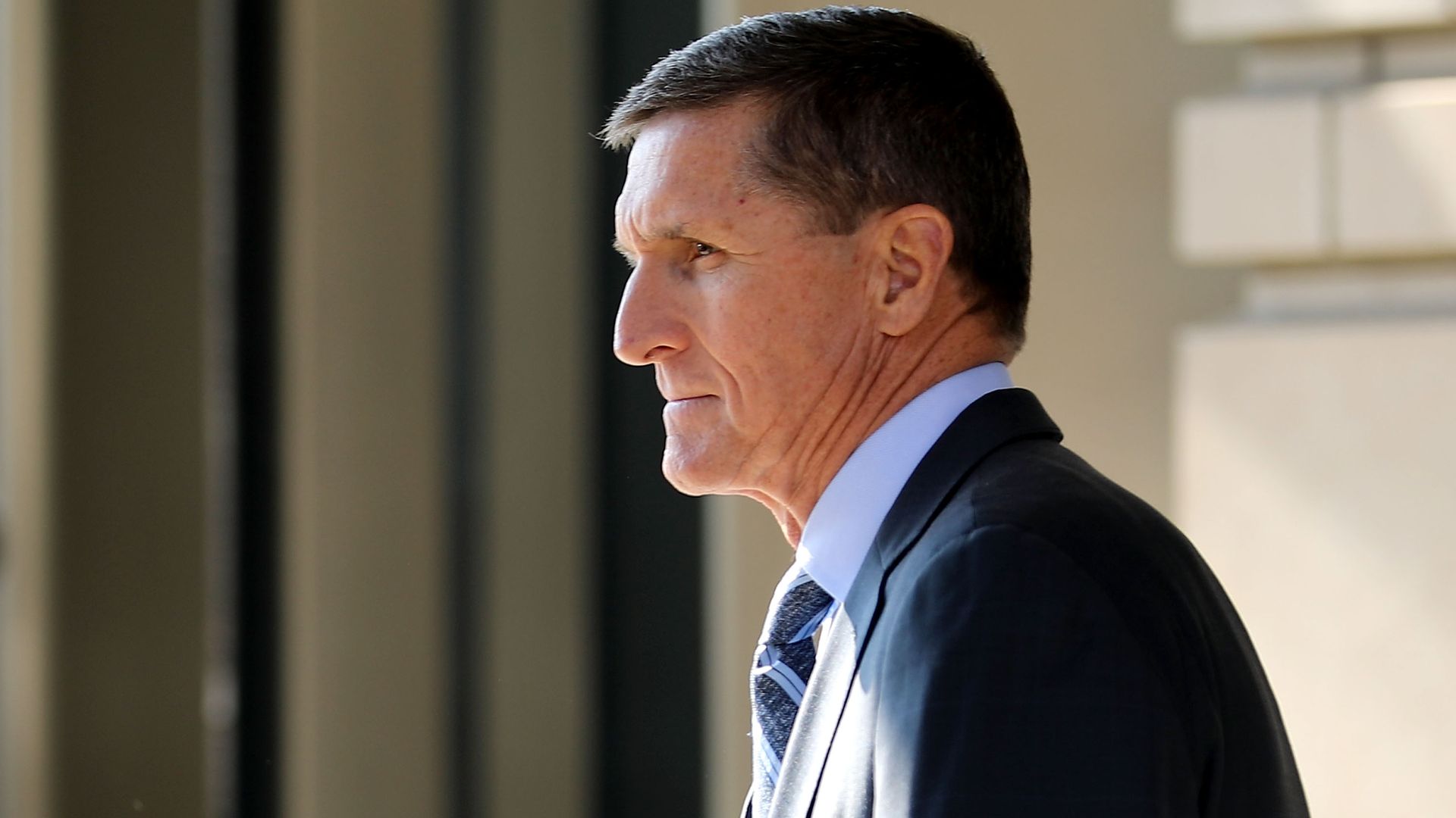 Michael Flynn outside in a suit. 