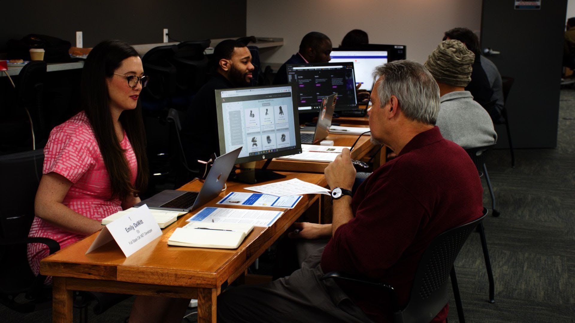 Students at Nashville Software School sit across the table from each other. 