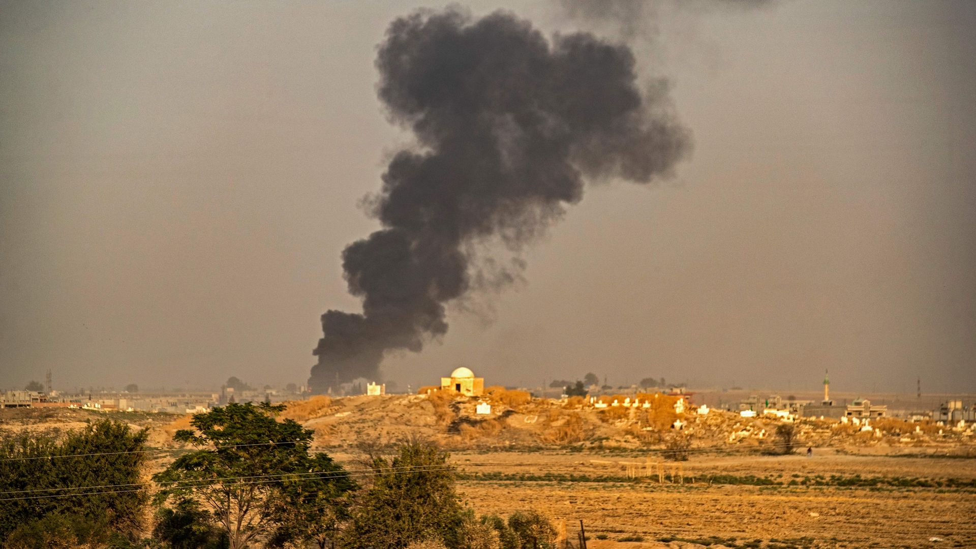 Smoke following Turkish bombardment on Syrian town of Ras al-Ain.