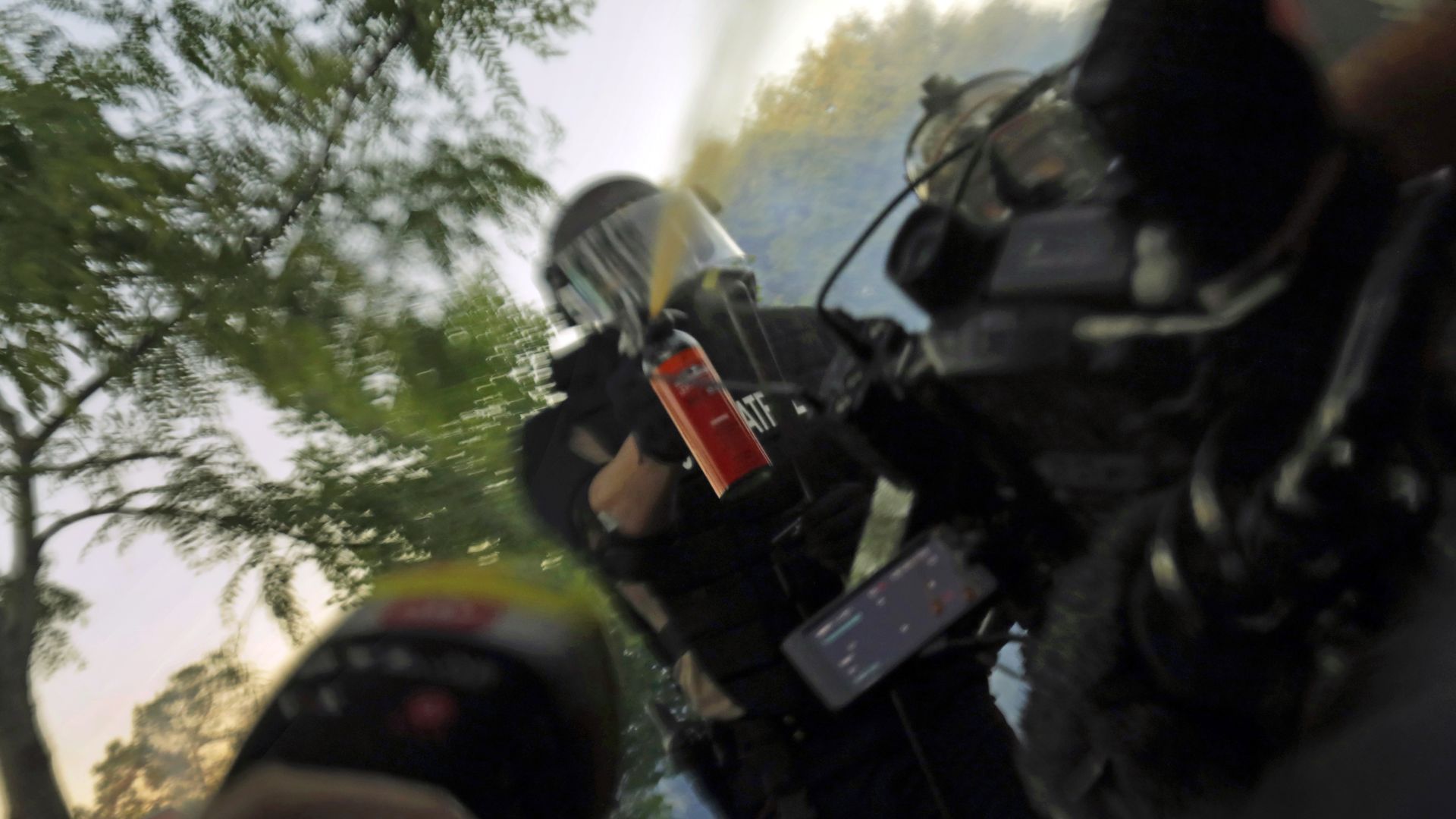 Picture of a Minnesota State Patrol officer spraying journalists with pepper spray