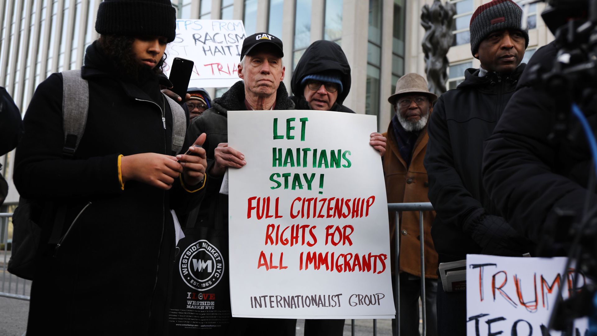 People demonstrate as a trial begins to try to protect Haitians immigrants under the Temporary Protected Status.