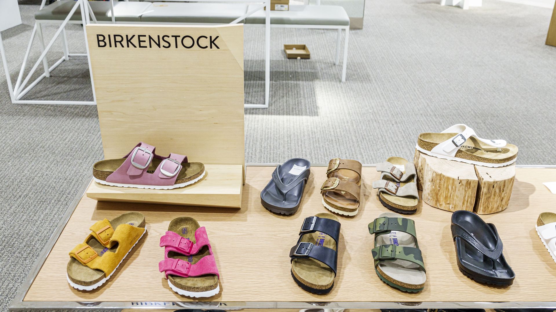 A row of different colored Birkenstock sandals in a display case