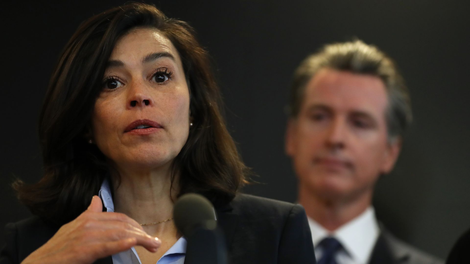 Gov. Gavin Newsom stands behind Dr. Sonia Angell