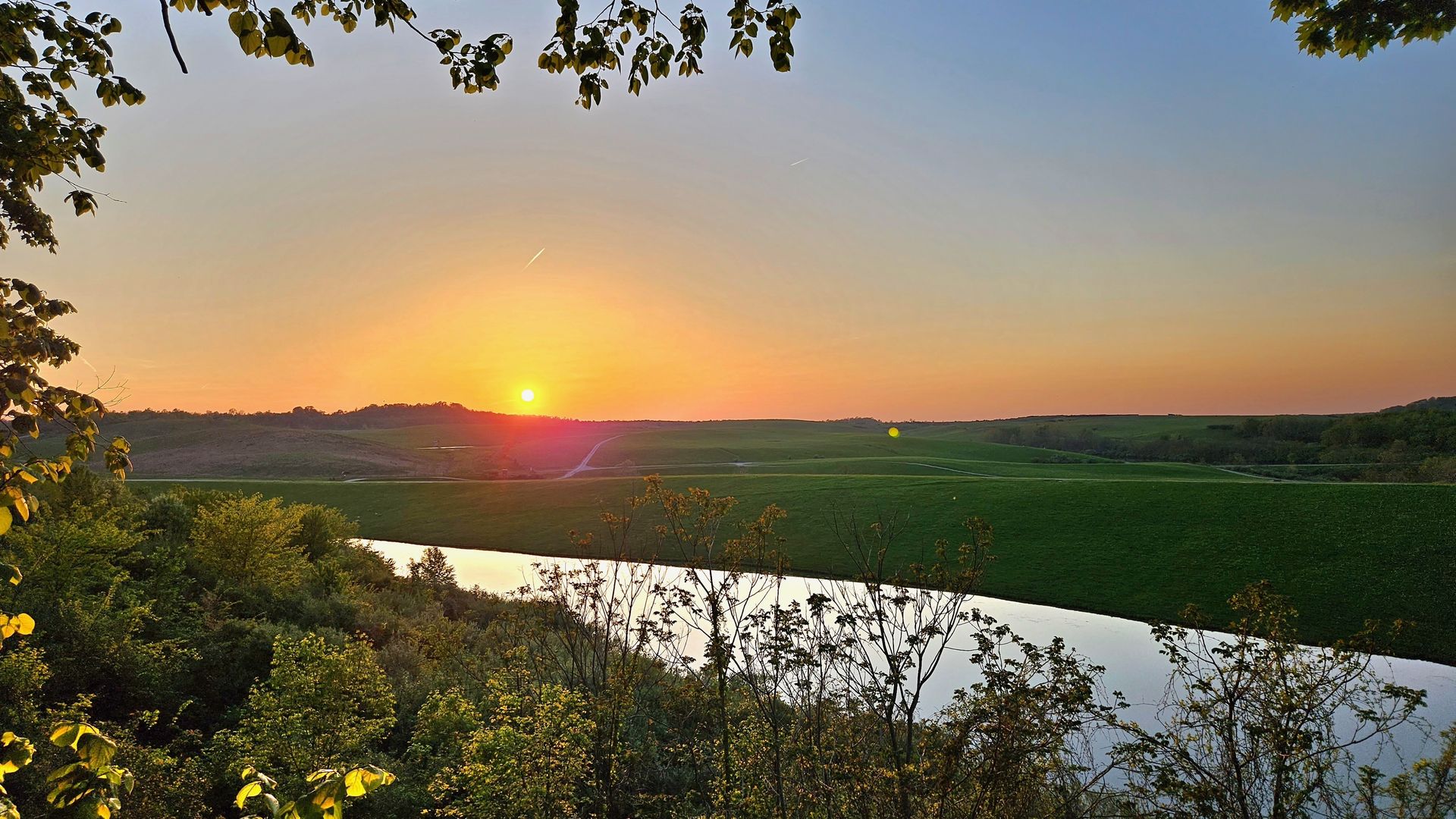 A sunset behind hills