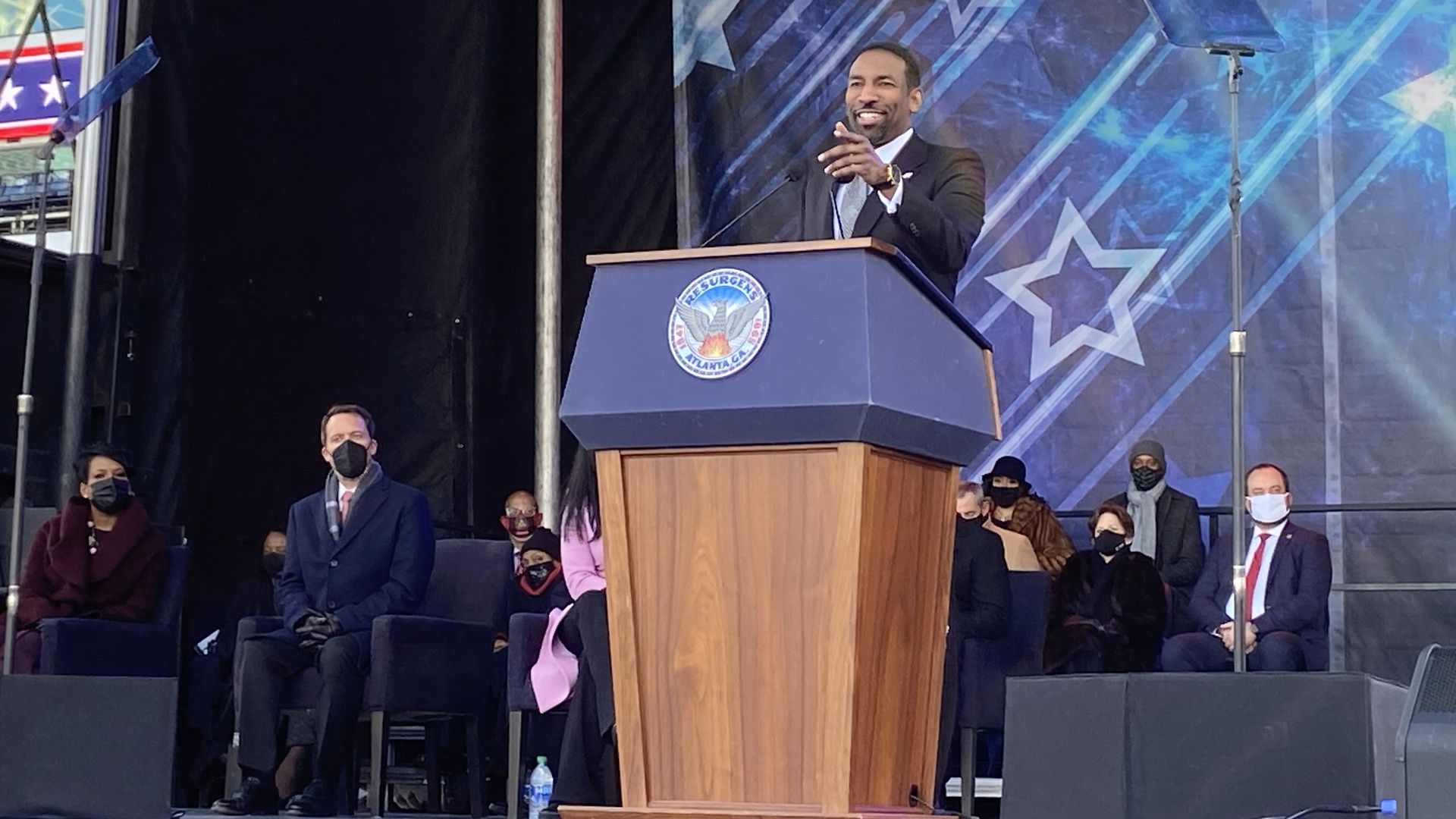 Andre Dickens points to the audience during his inauguration speech at Georgia Tech's Bobby Dodd football stadium.