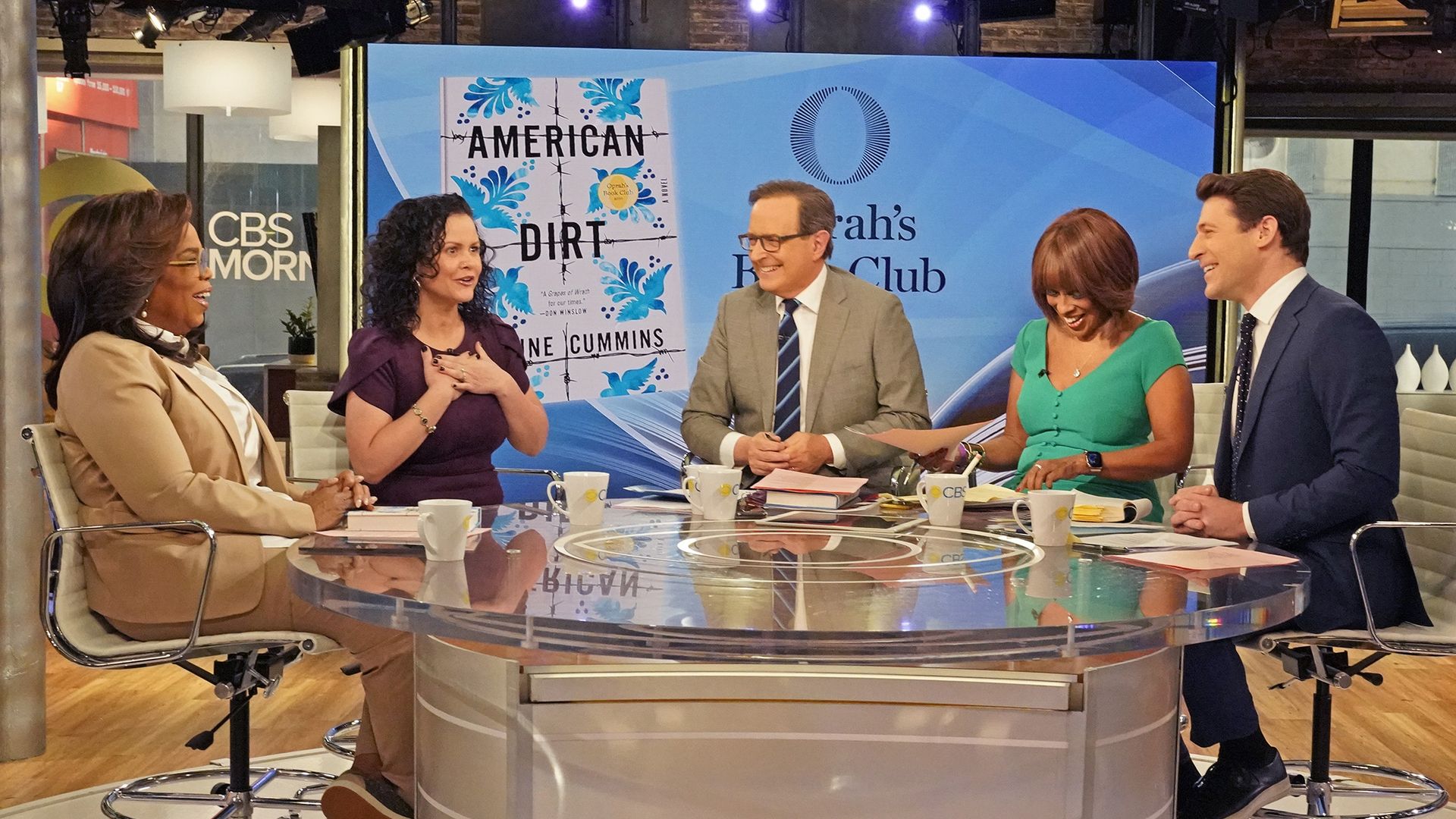 Jeanine Cummins and Oprah on a TV set.