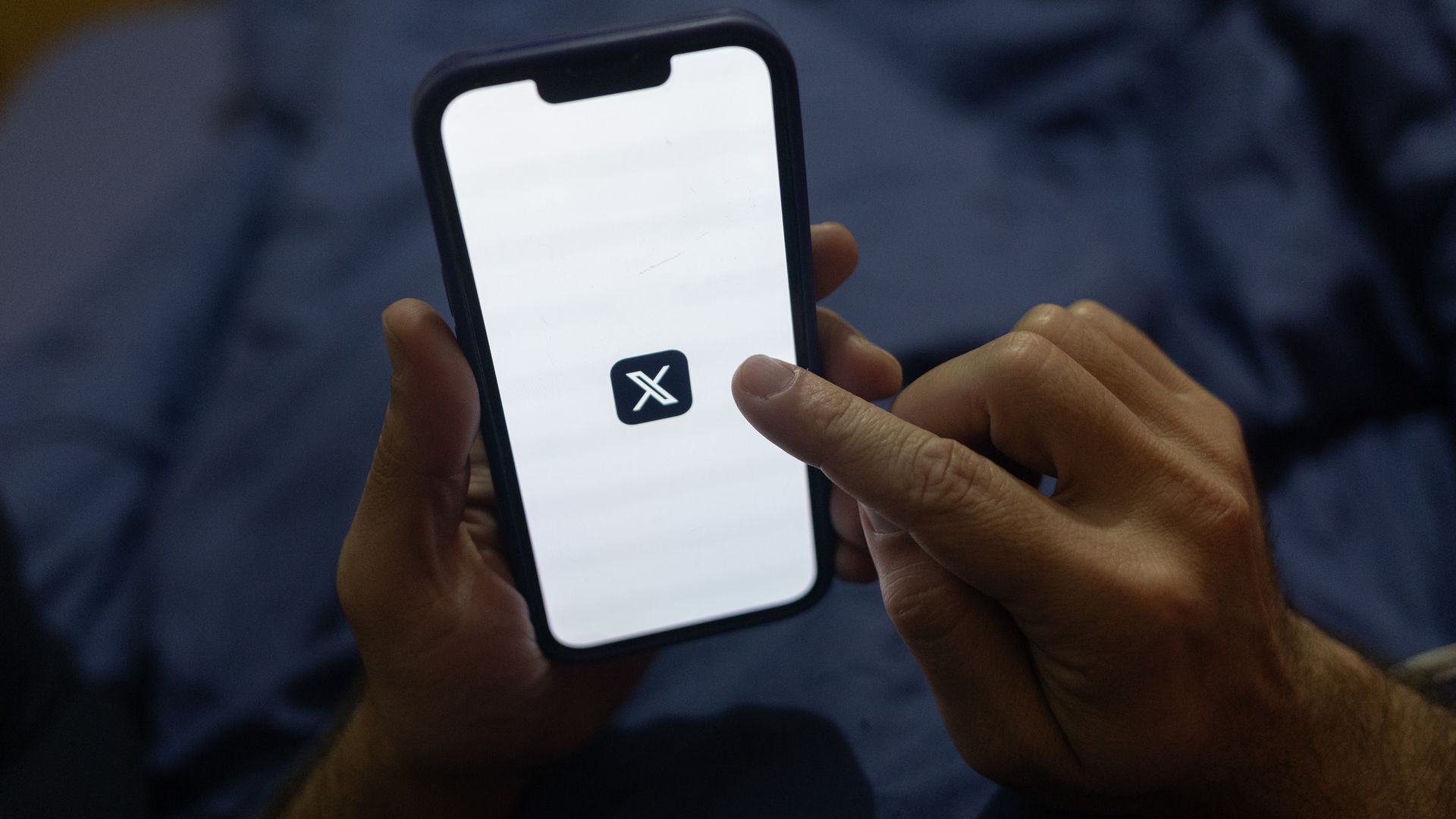 The logo of X, the social media platform formerly known as Twitter, displayed on a smartphone in Sao Paulo, Brazil