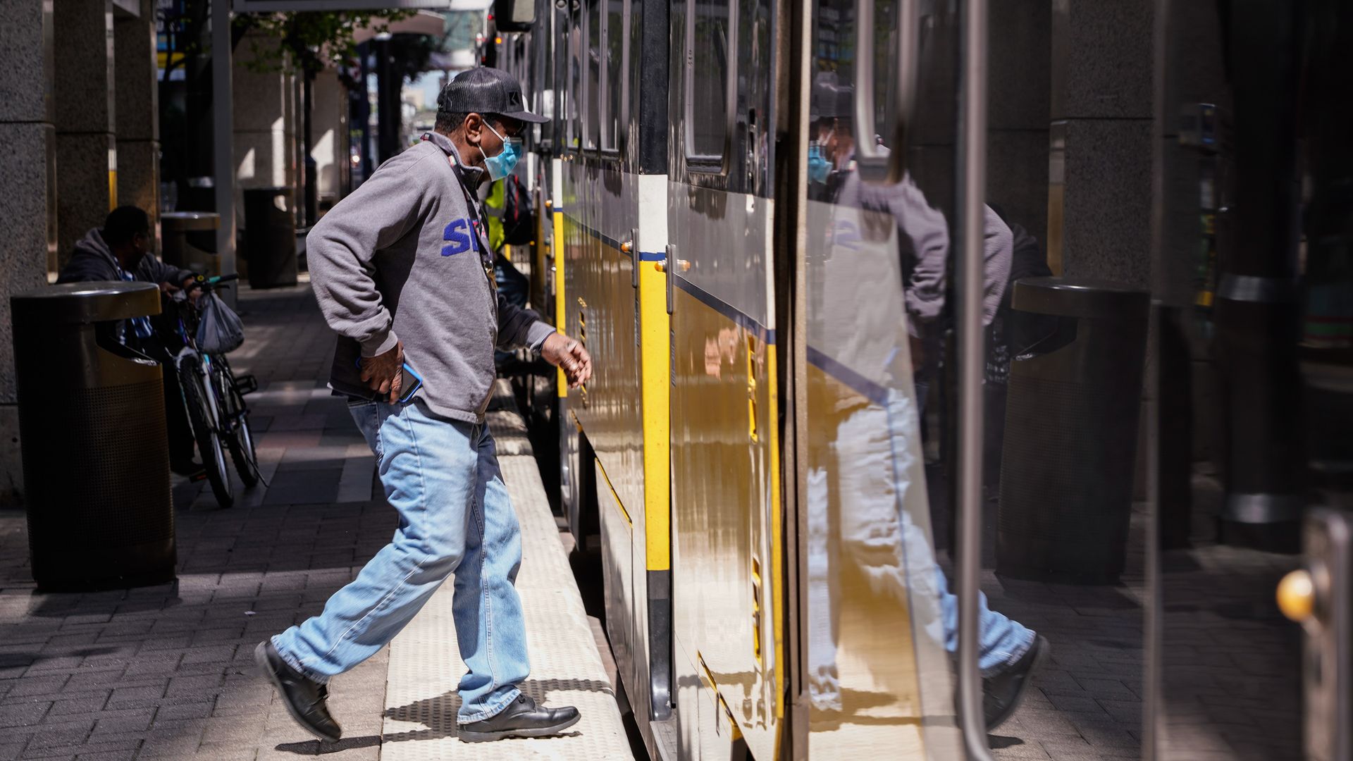 A man gets on a Dallas light rail train