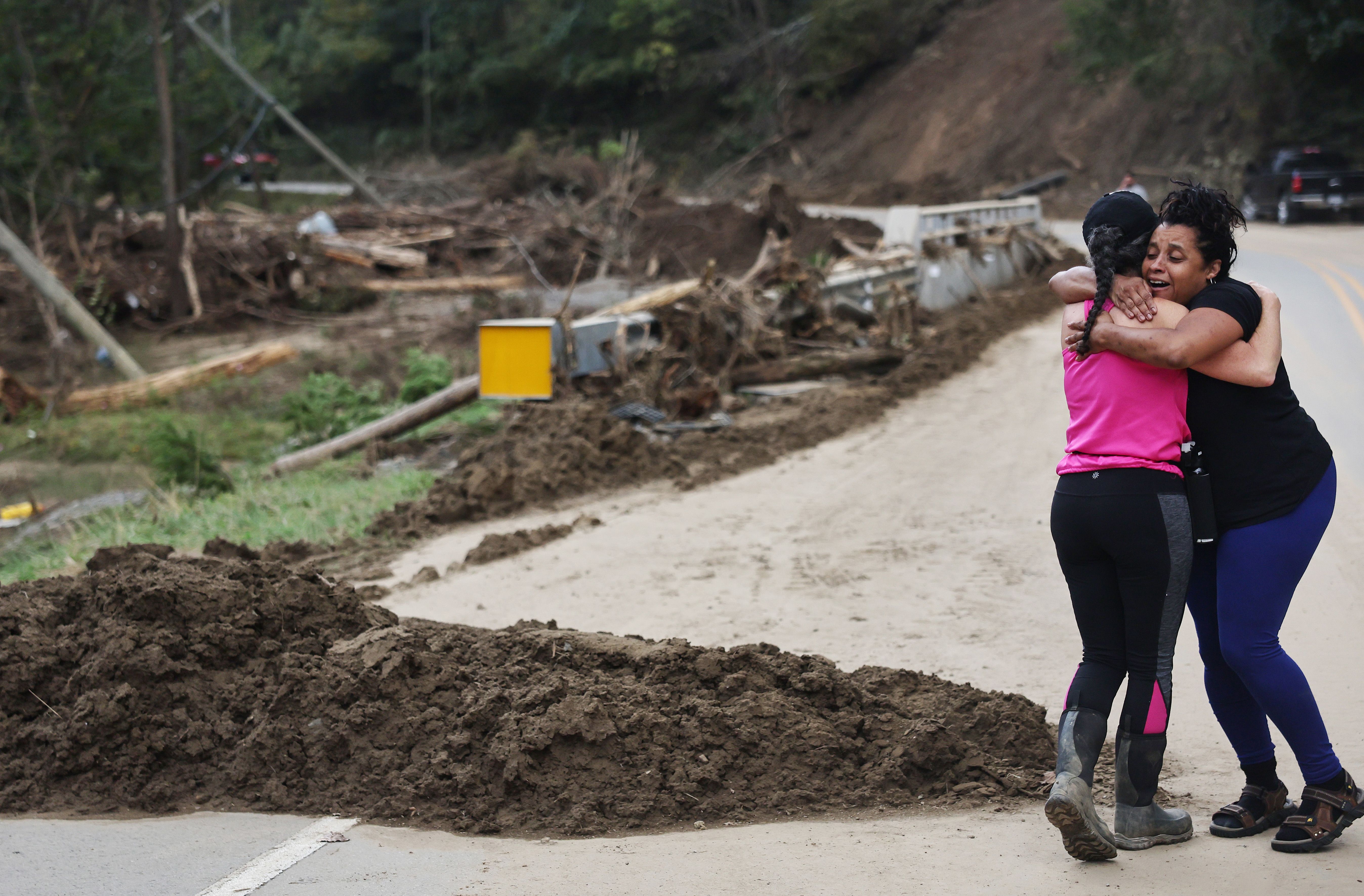 Tammie Mance (R) hugs her boss Liesl Steiner, whose home was destroyed, as they see each other for the first time since the storm in the aftermath of Hurricane Helene flooding on October 3, 2024 in Black Mountain, North Carolina.