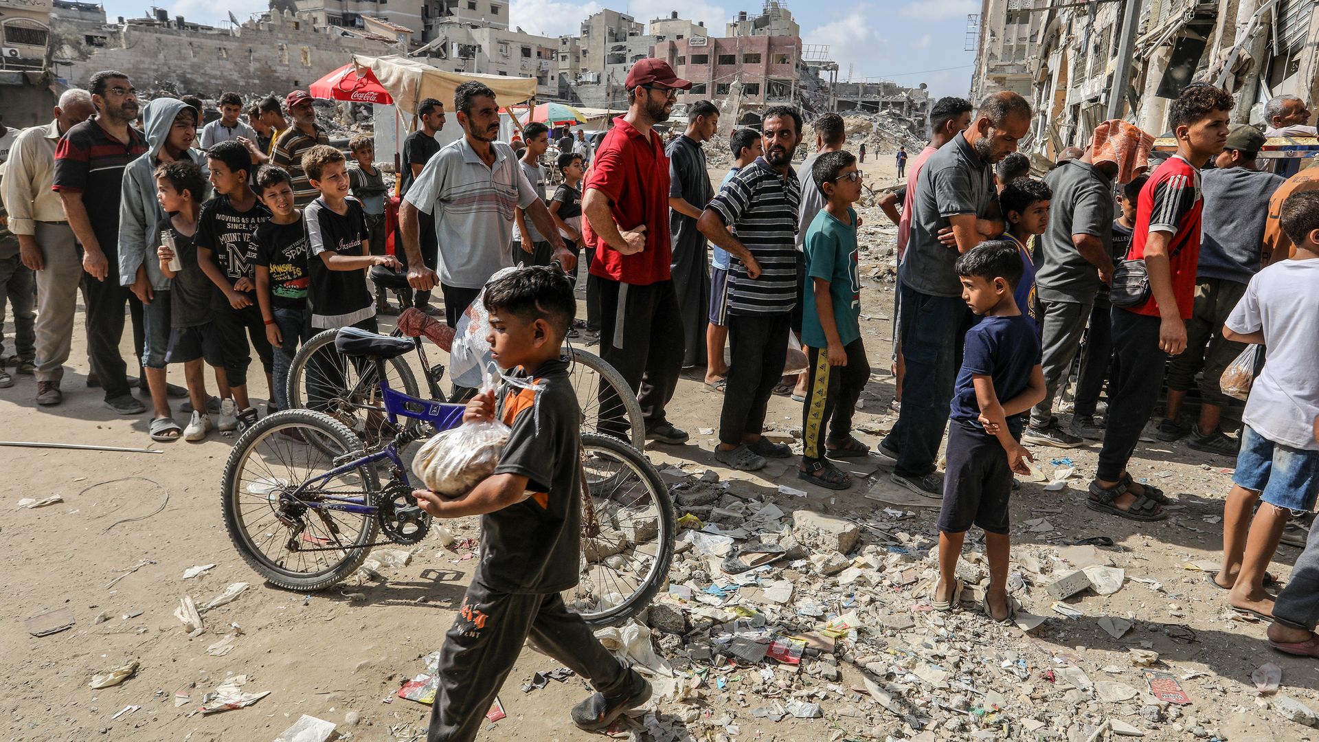 Palestinians line up in front of a bakery opened with the support of World Food Programme (WFP) and the United Nations Relief and Works Agency for Palestine Refugees in the Near East (UNRWA) for bread in Khan Yunis, Gaza on September 08, 2024. (Photo by Abed Rahim Khatib/Anadolu via Getty Images)