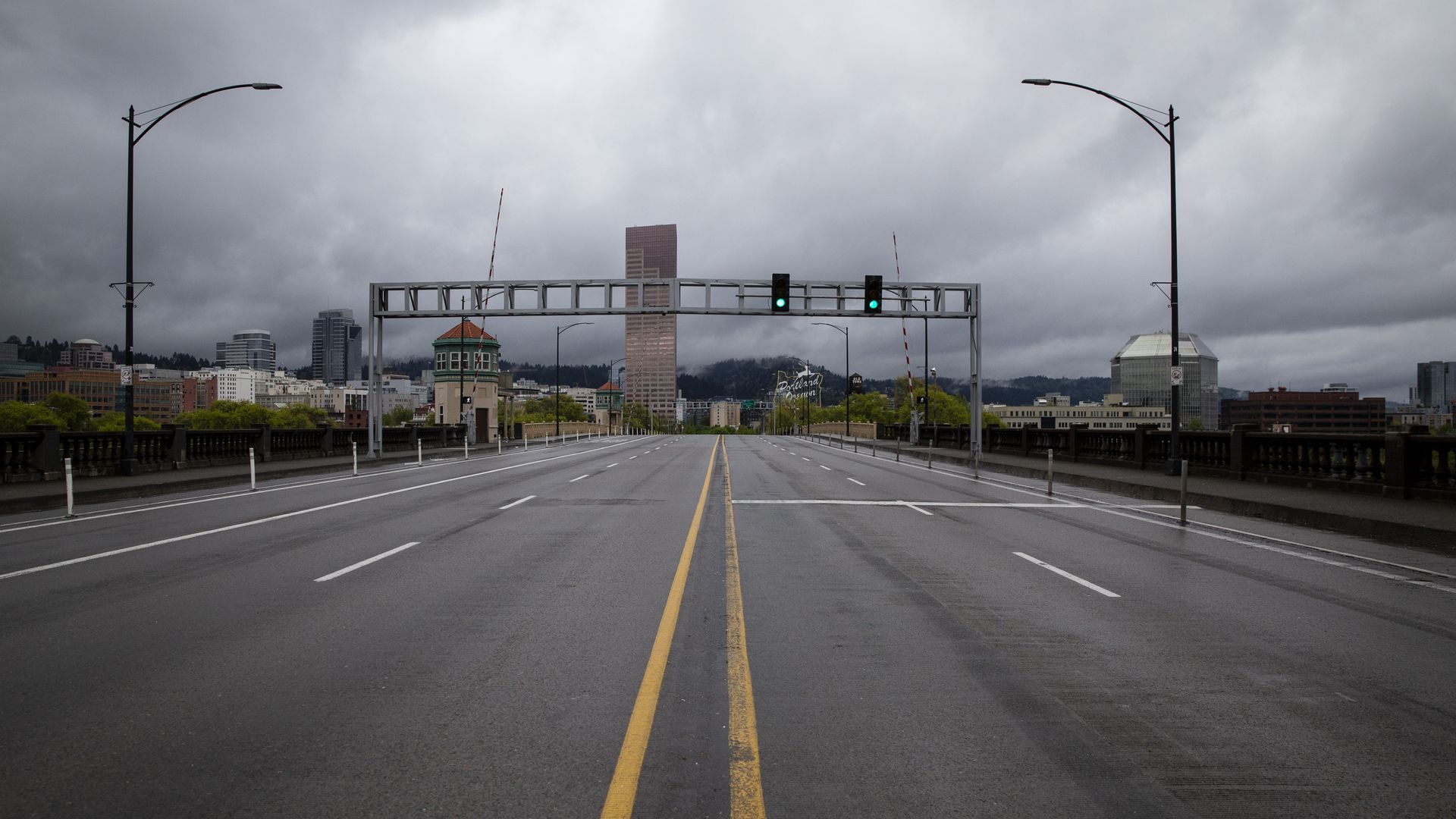 A photo of an empty street facing the Portland skyline.