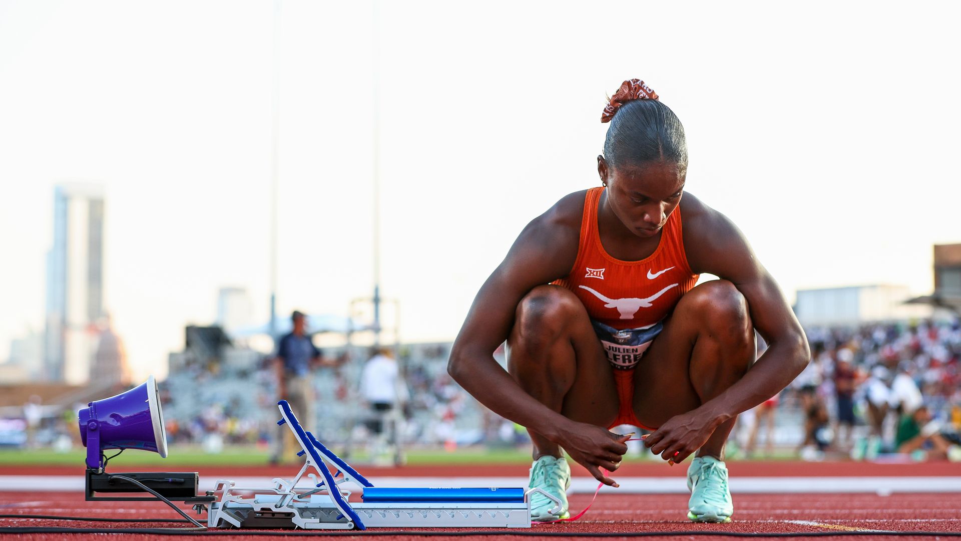 A photo of Julien knelt down on the track.