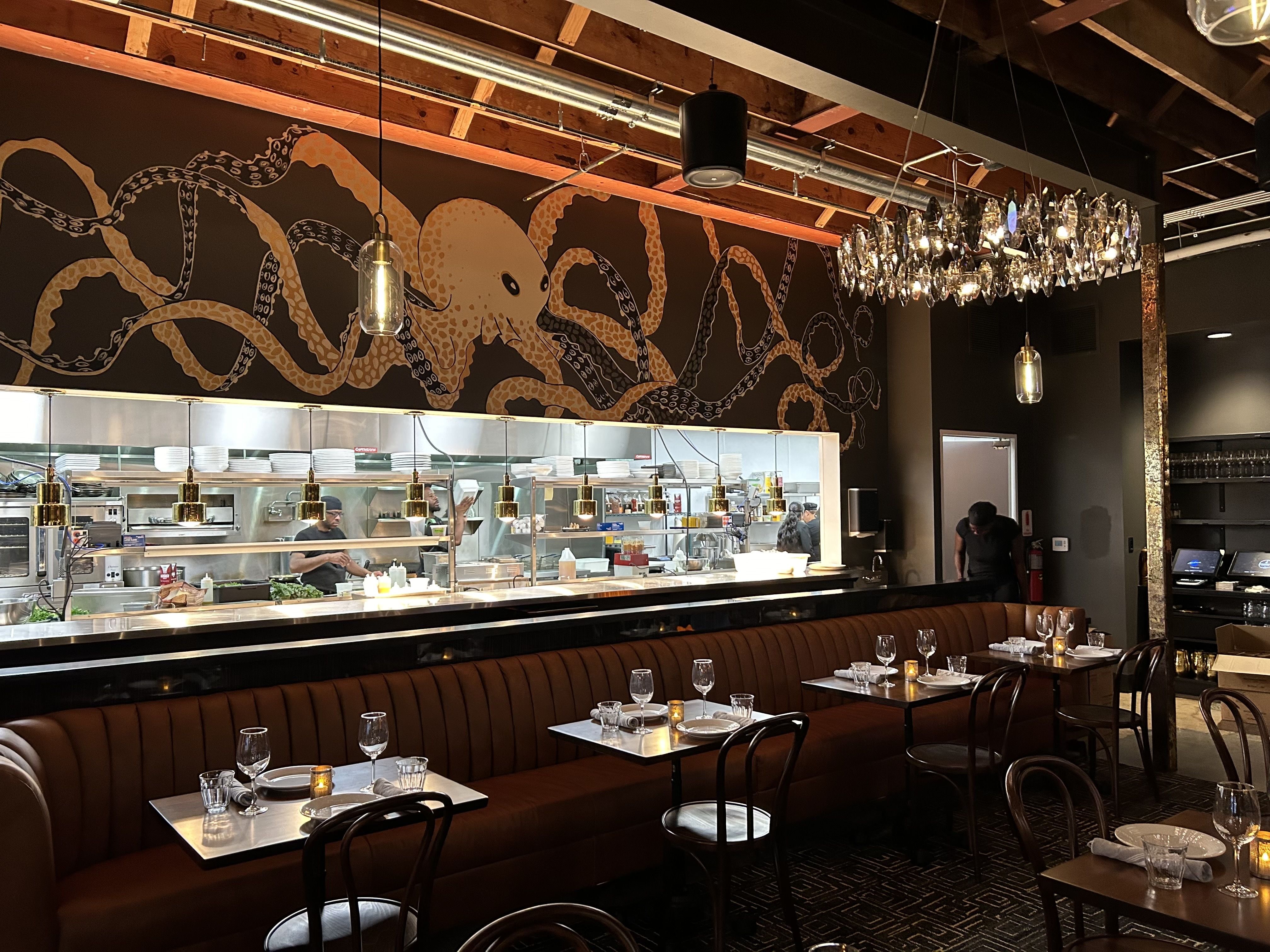 open kitchen with large squid mural above