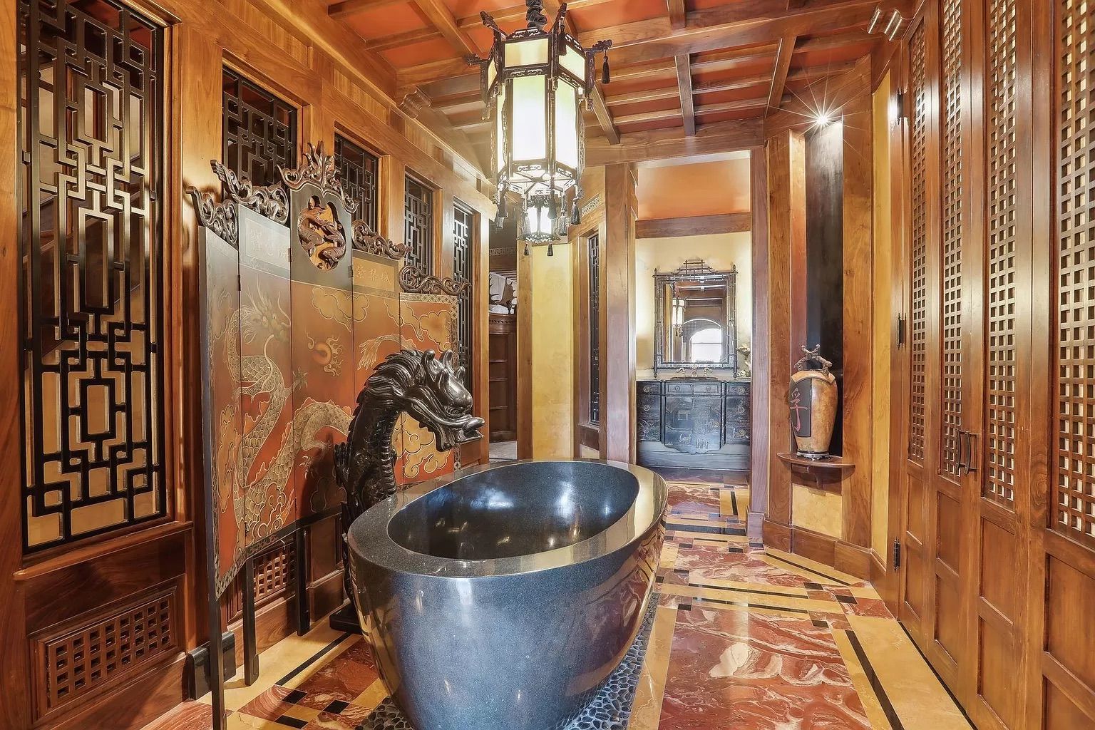 A bathroom with a marble tub shaped like a dragon