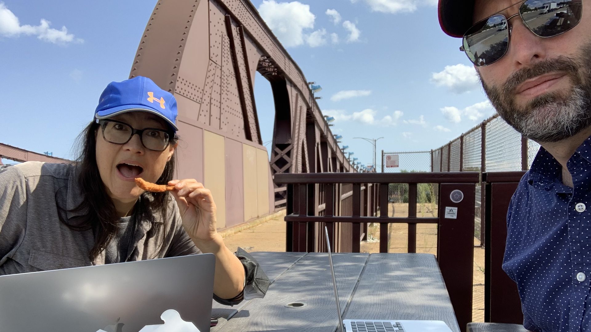 Two people at a table outdoors. 