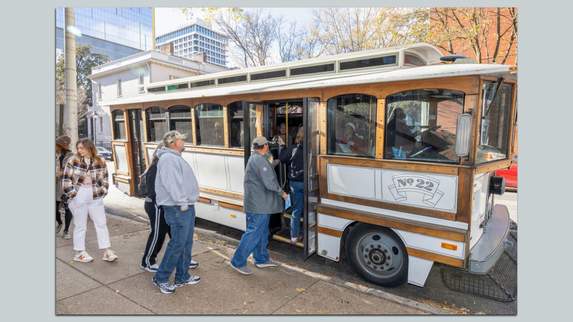 People get onboard a trolley 