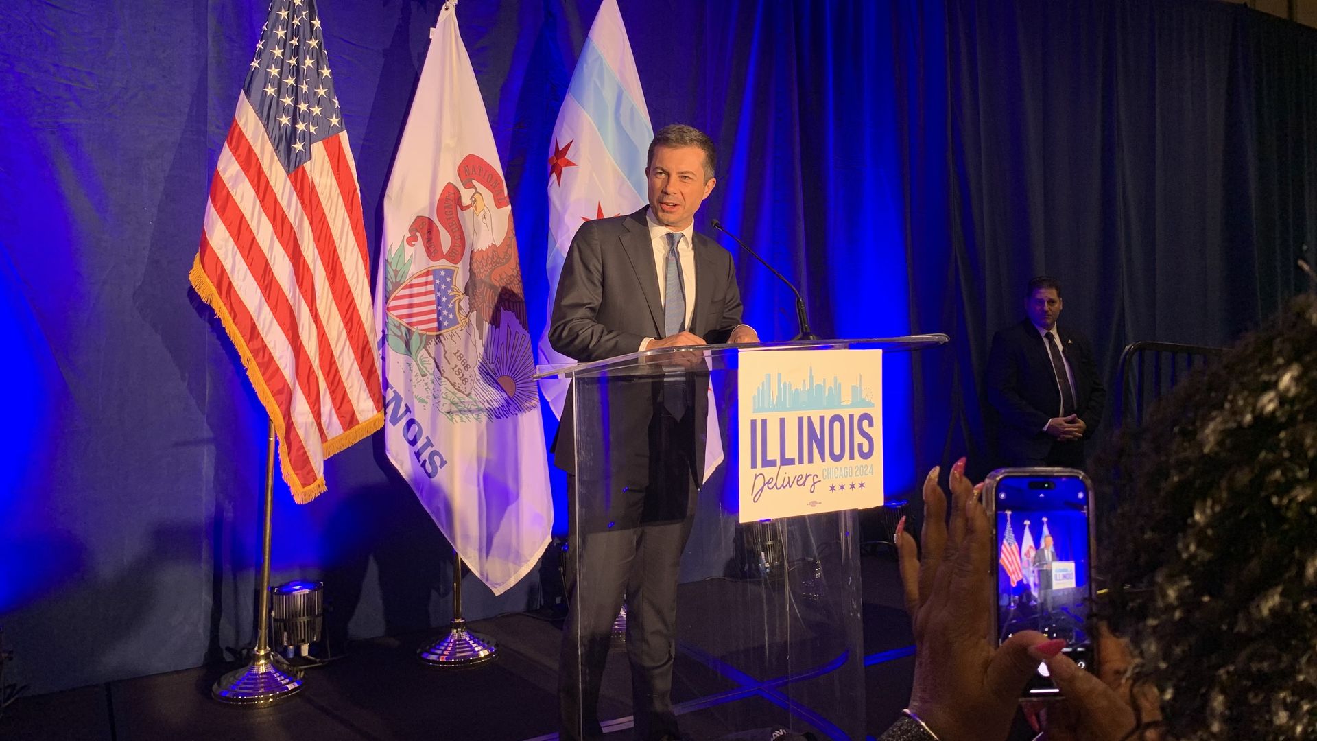 Photo of a man standing in front of a podium 