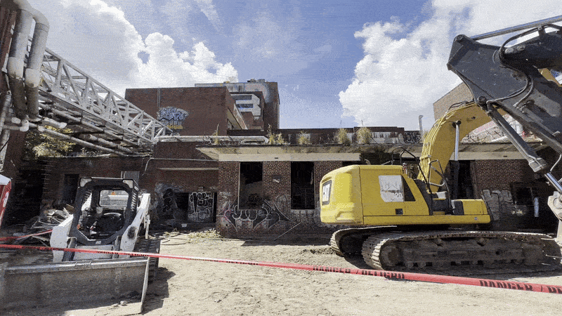 Image shows a blighted building with heavy equipment.