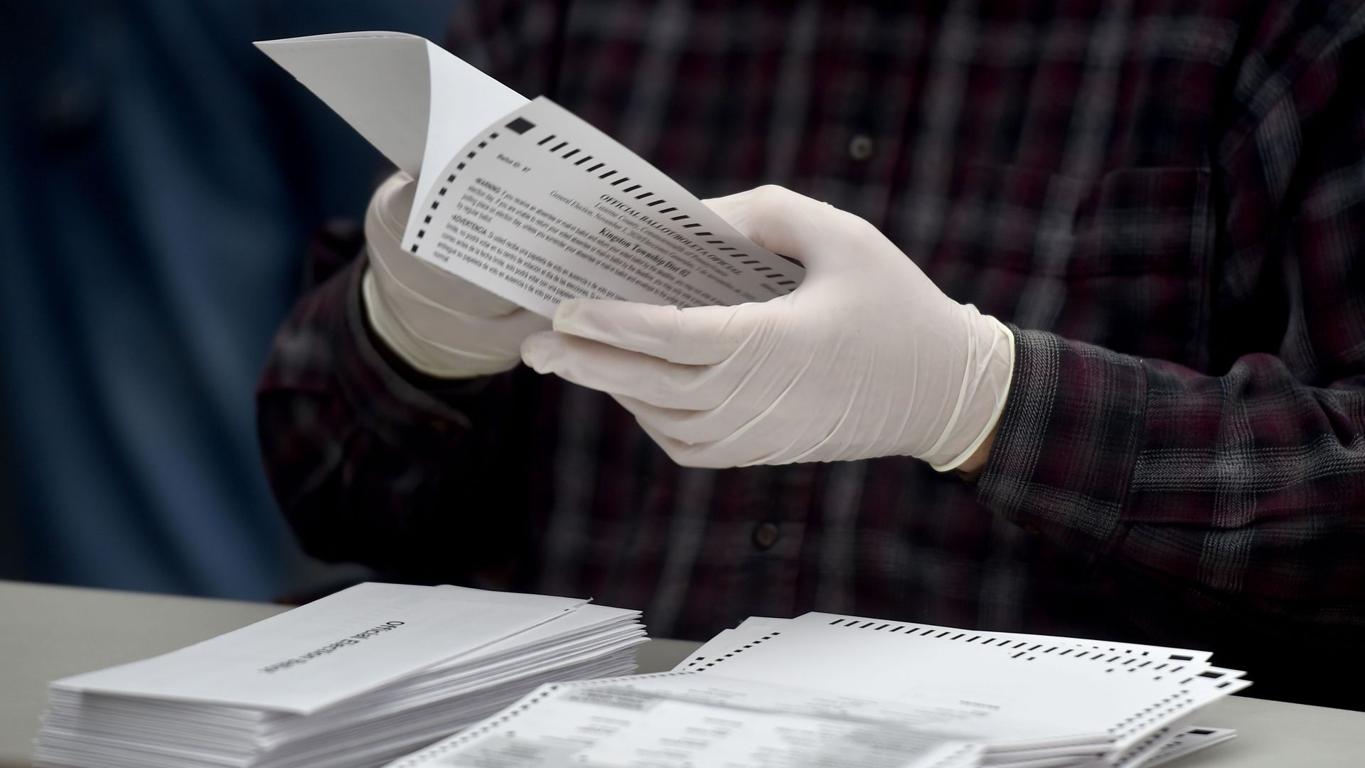 A person counts ballots.