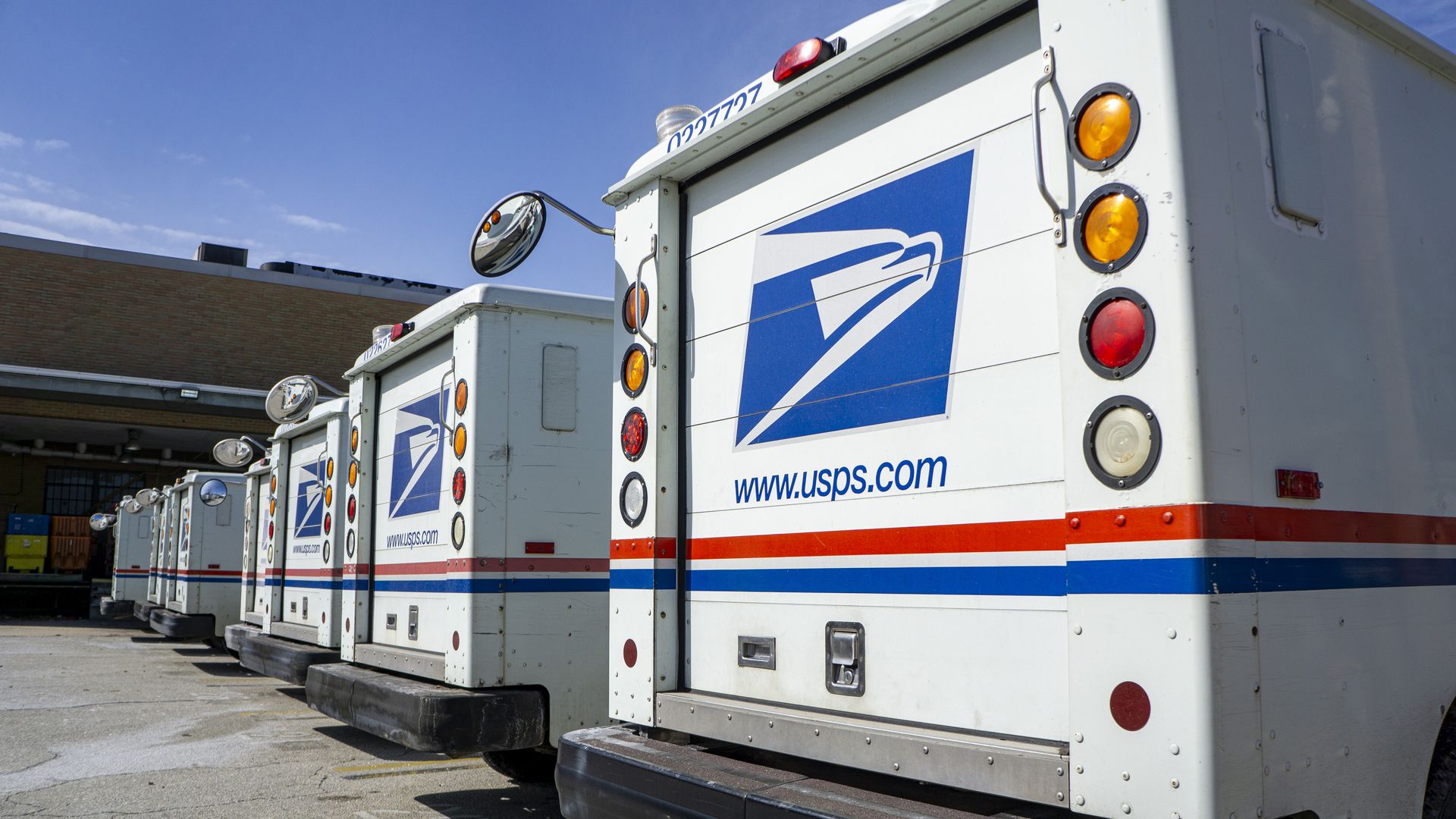 several postal trucks parked in a line