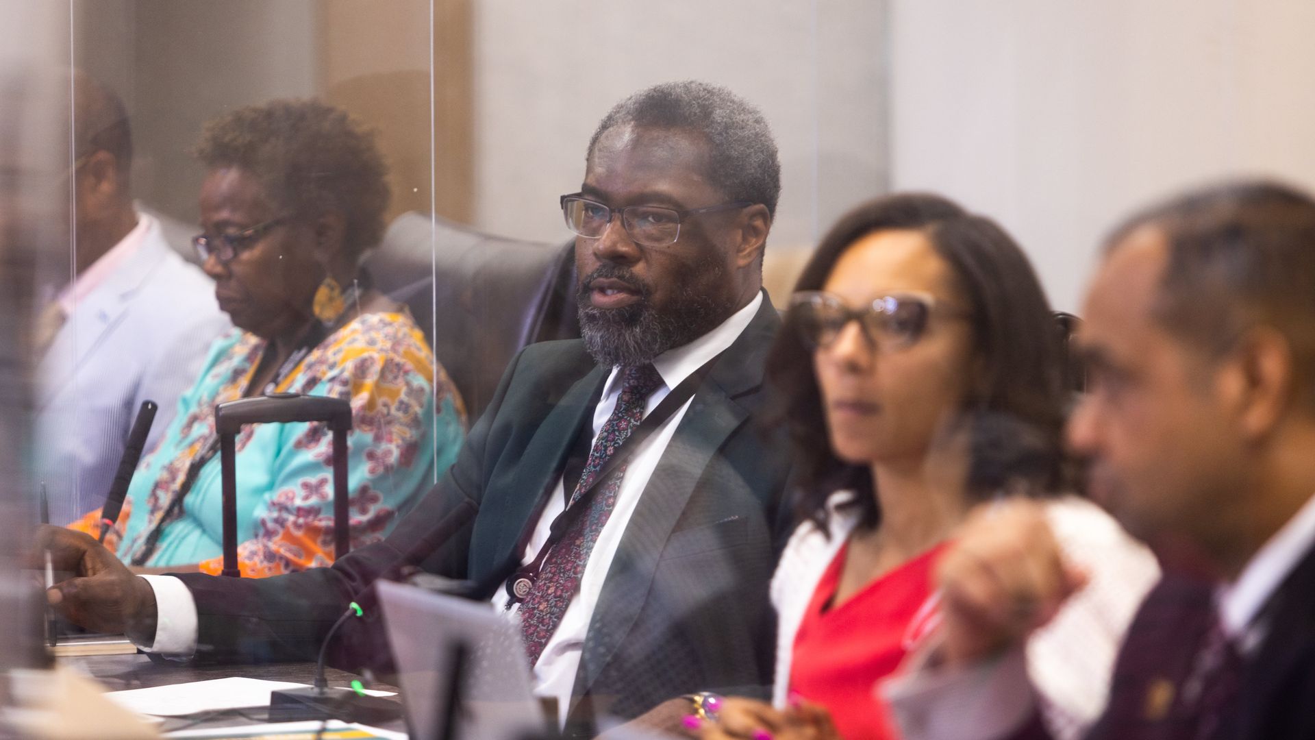 City Council members sit at their desks during a meeting.