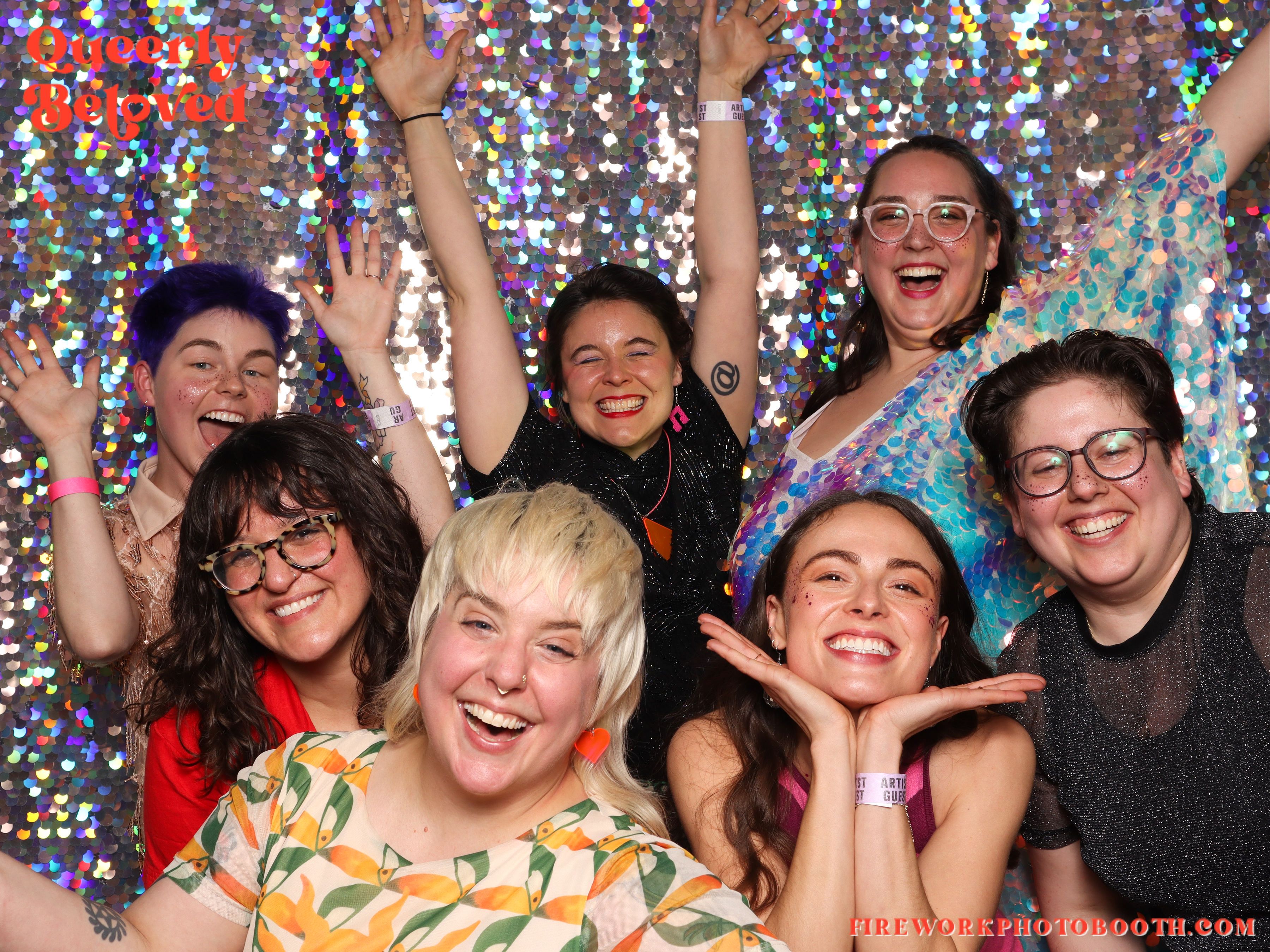 Seven people who organized the "Queerly Beloved" wedding ceremonies and public reception pose for a group photo in a photo booth. 