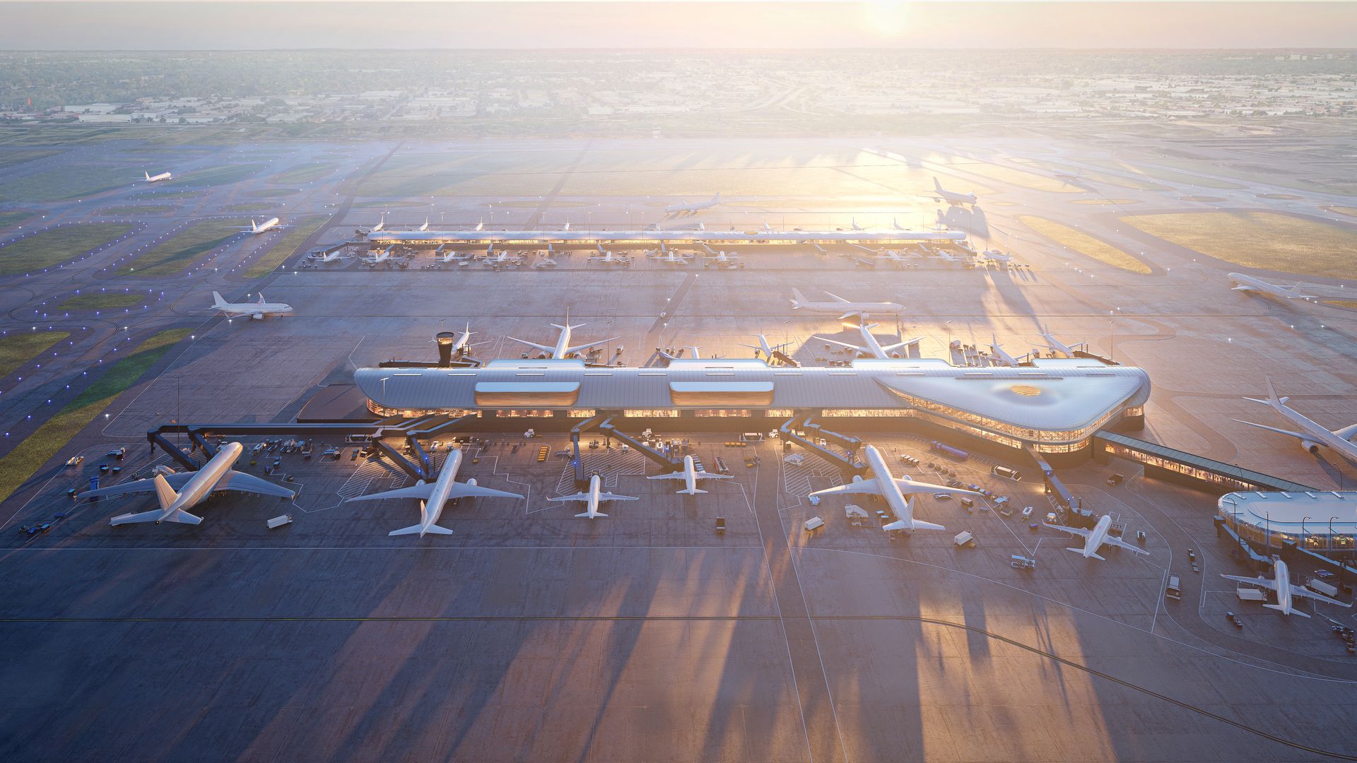 Aerial view of a large airport terminal with multiple airplanes parked at gates during sunset, casting long shadows on the runway and apron area.