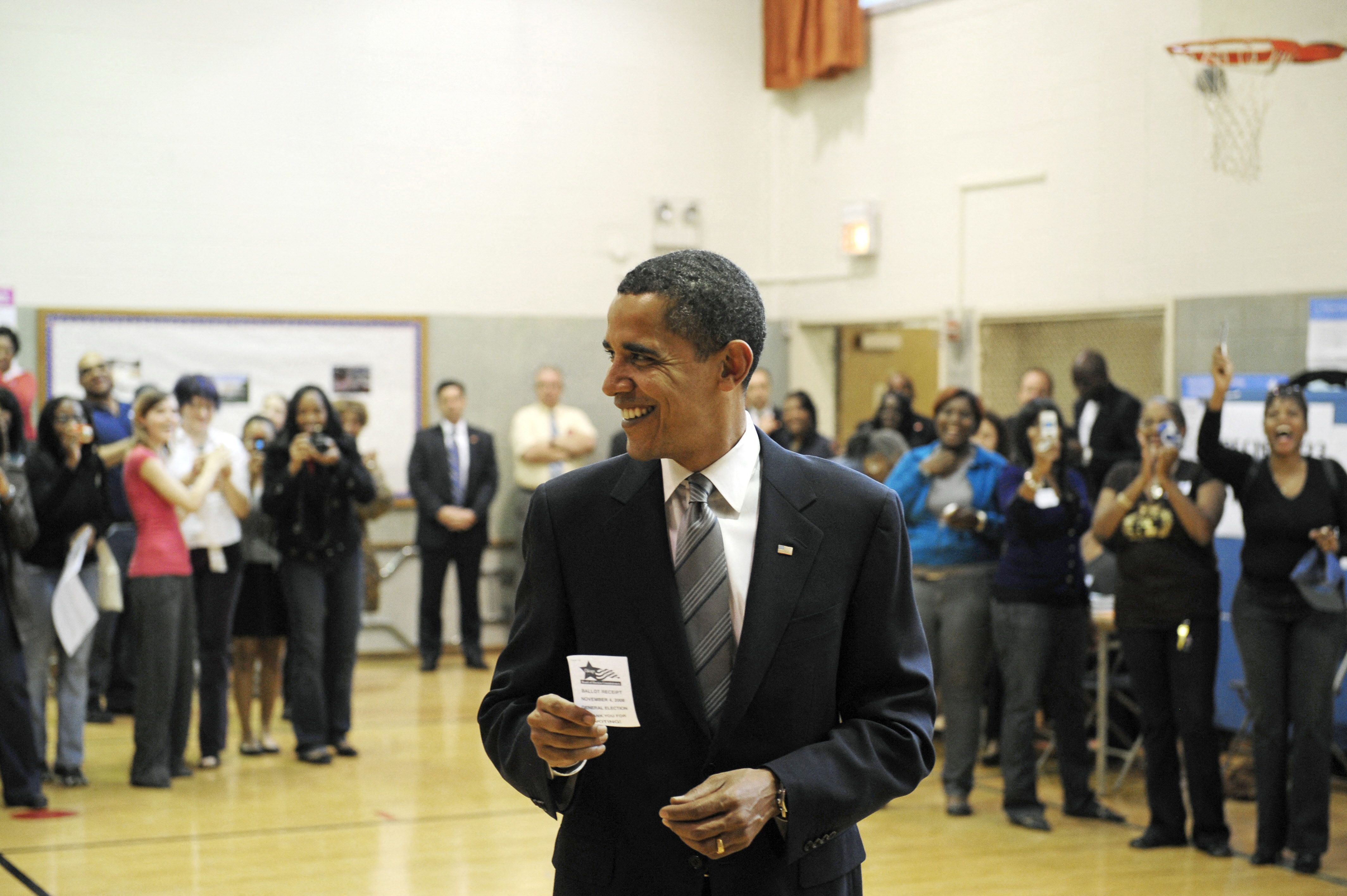 Photo of a man holding a voting receipt