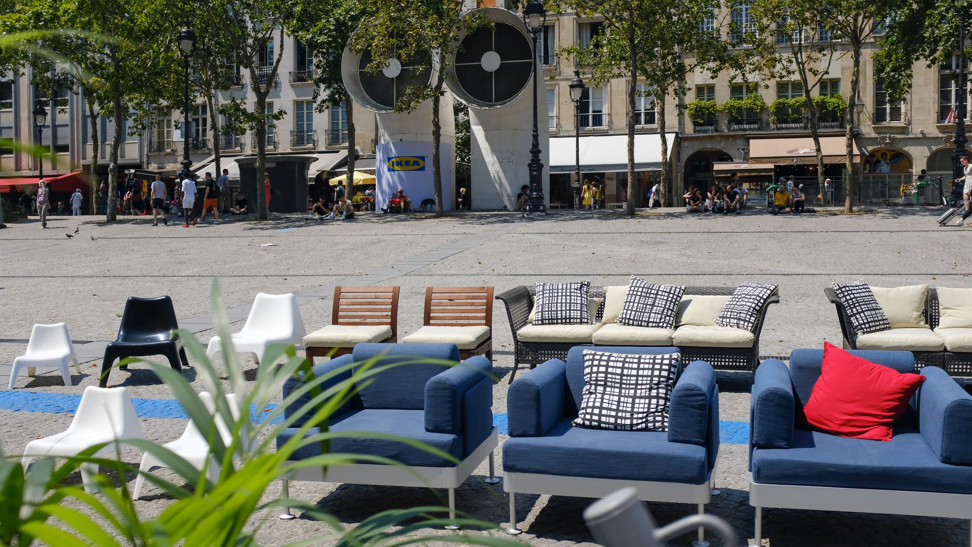 Blue and white couches sitting on a street