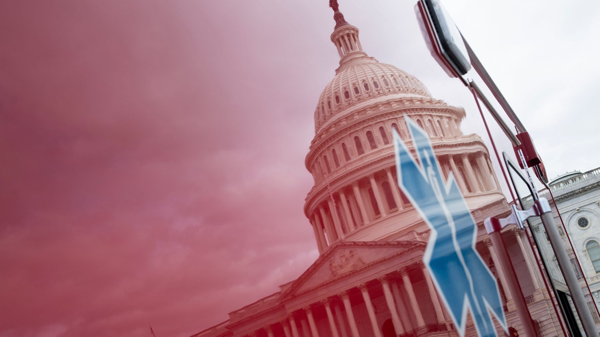 A photo of the U.S. Capitol building reflected in an ambulance.