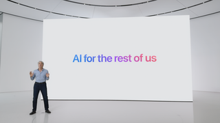 Photo of Apple's Craig Federighi standing in front of screen reading "AI for the rest of uas"