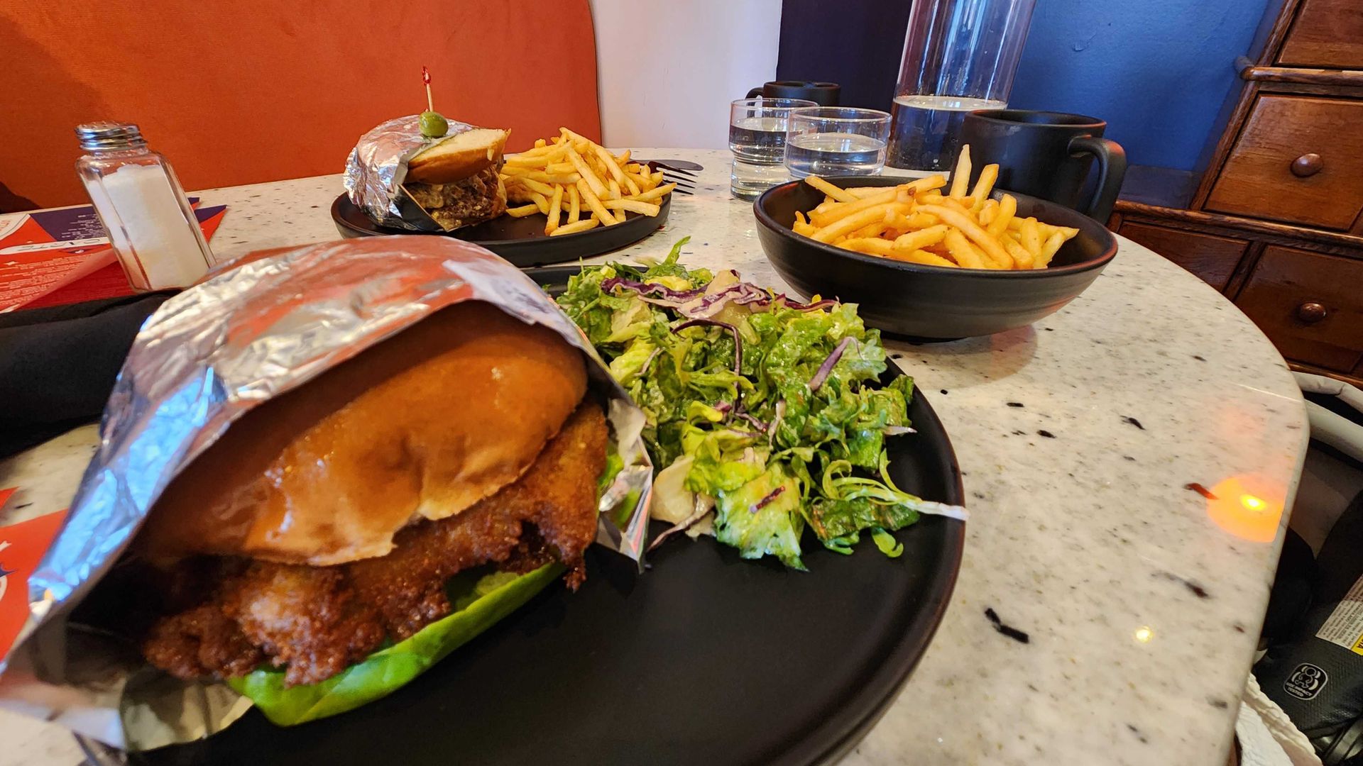 Sandwiches and fries on a diner counter.