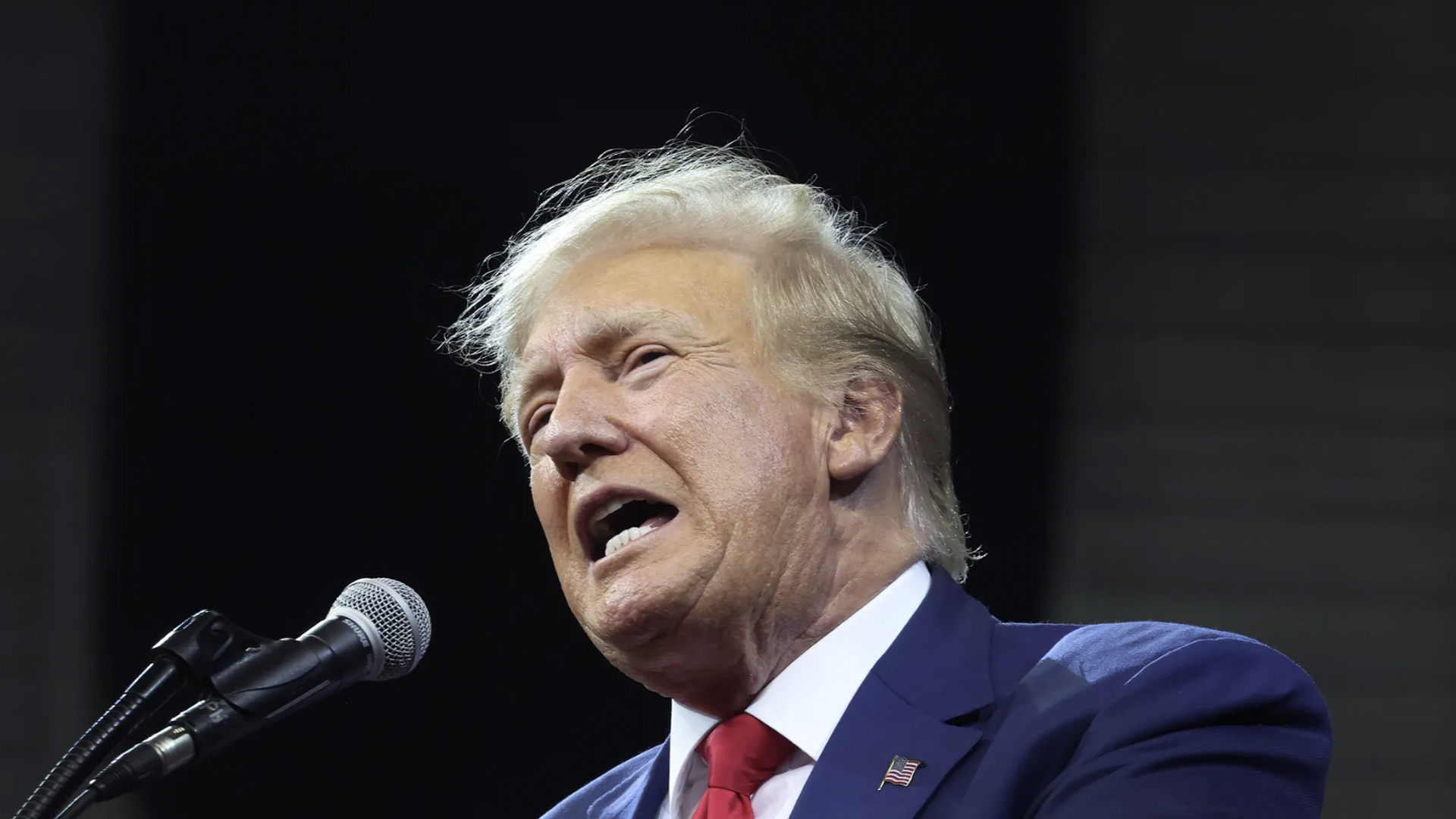 trump at a microphone