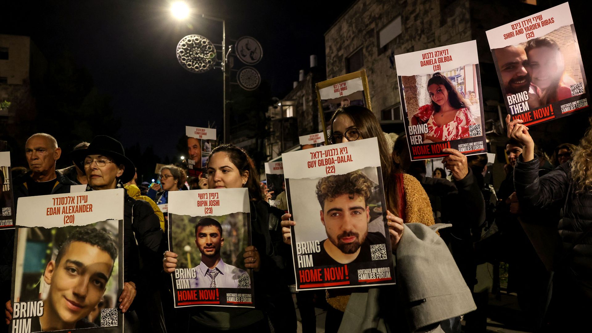 Protestors hold up portraits during a rally organised by family and supporters of Israeli hostages held in Gaza since the October 7 attacks by Hamas in southern Israel, to demand their release, on January 22, 2024