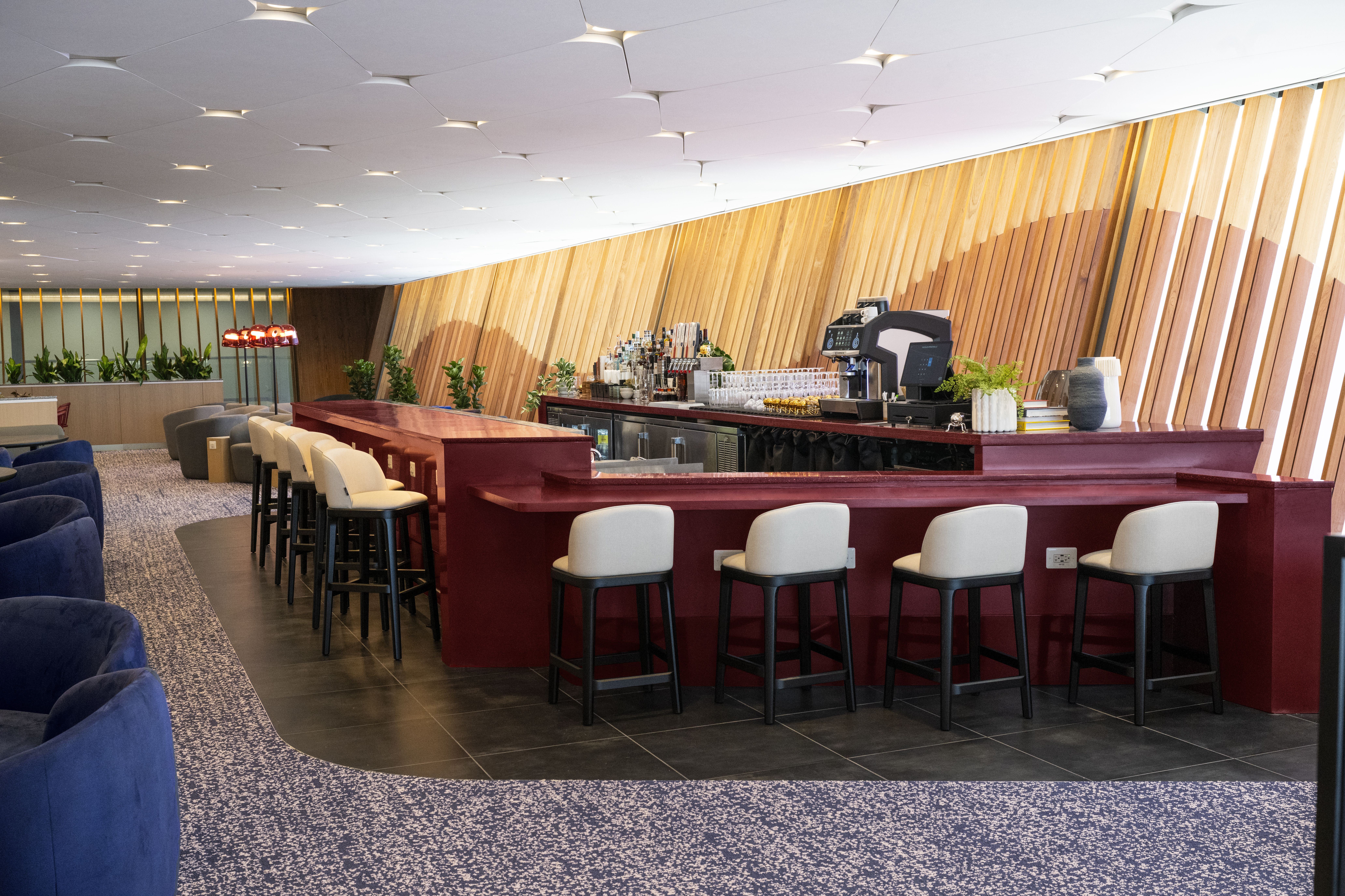 A bar lined with bar stools.
