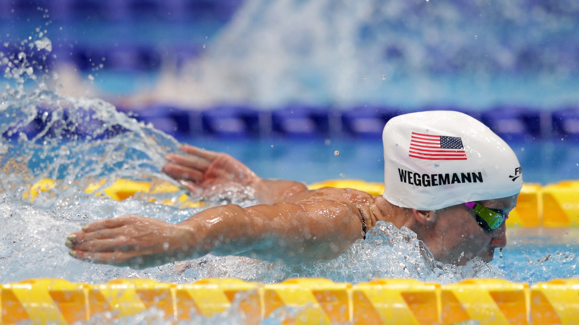 woman with a white cap with USA flag in a pool