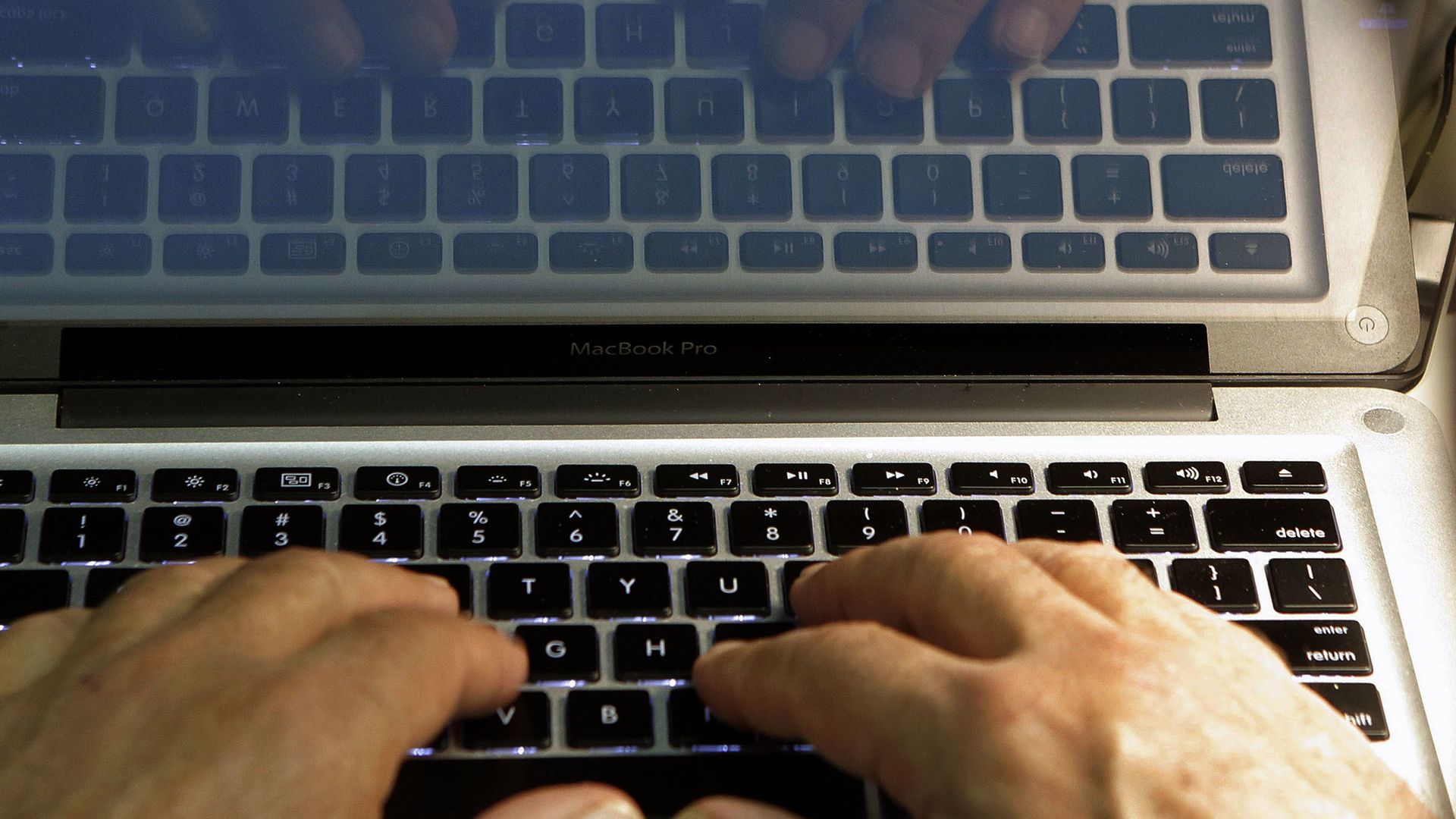 Hands type on a computer keyboard in Los Angeles.