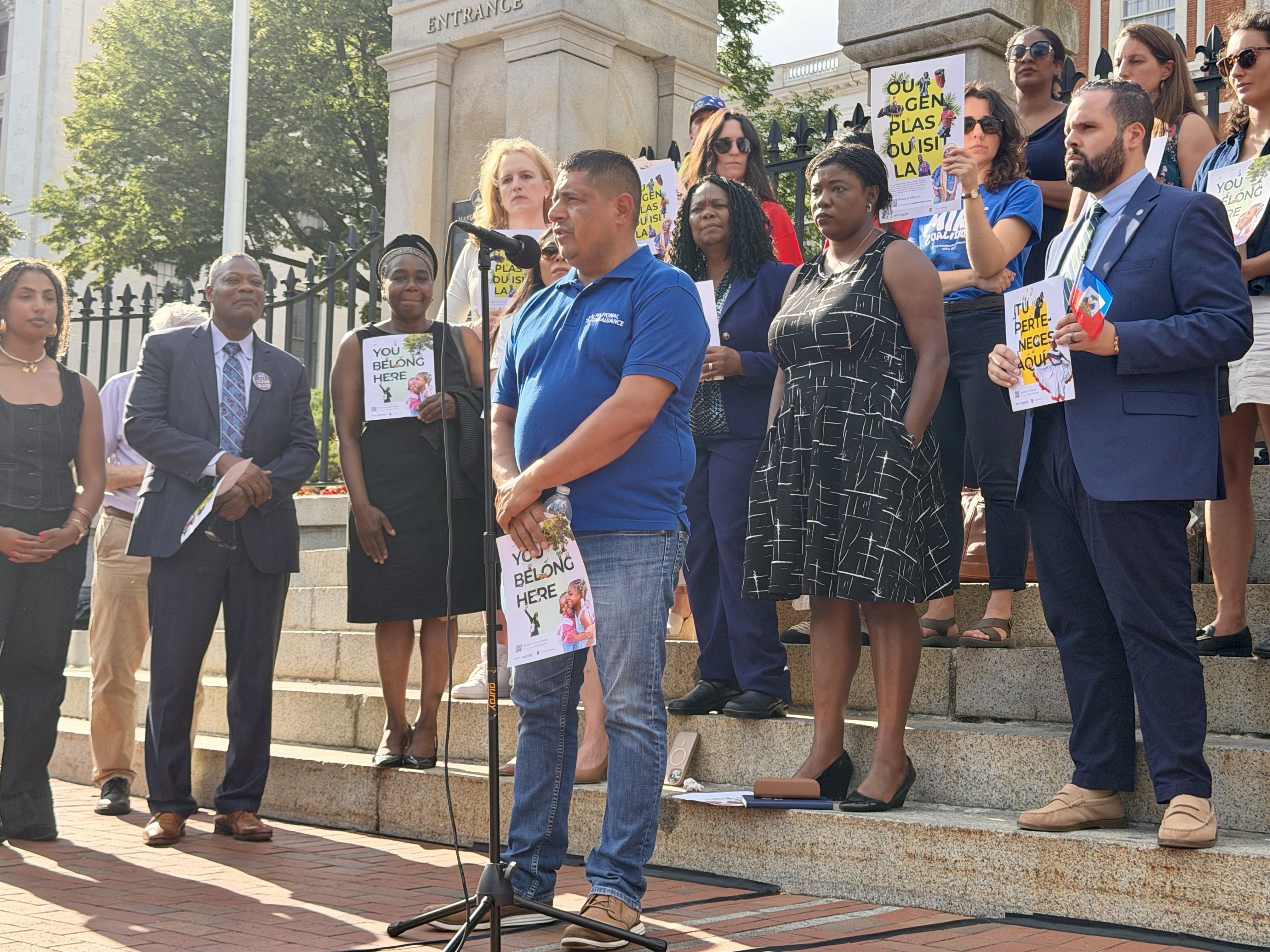 Jose Uribe, a TPS holder from El Salvador, speaks into a microphone at the foot of the Massachusetts State House on June 24 after the Supreme Court's ruling on TPS.